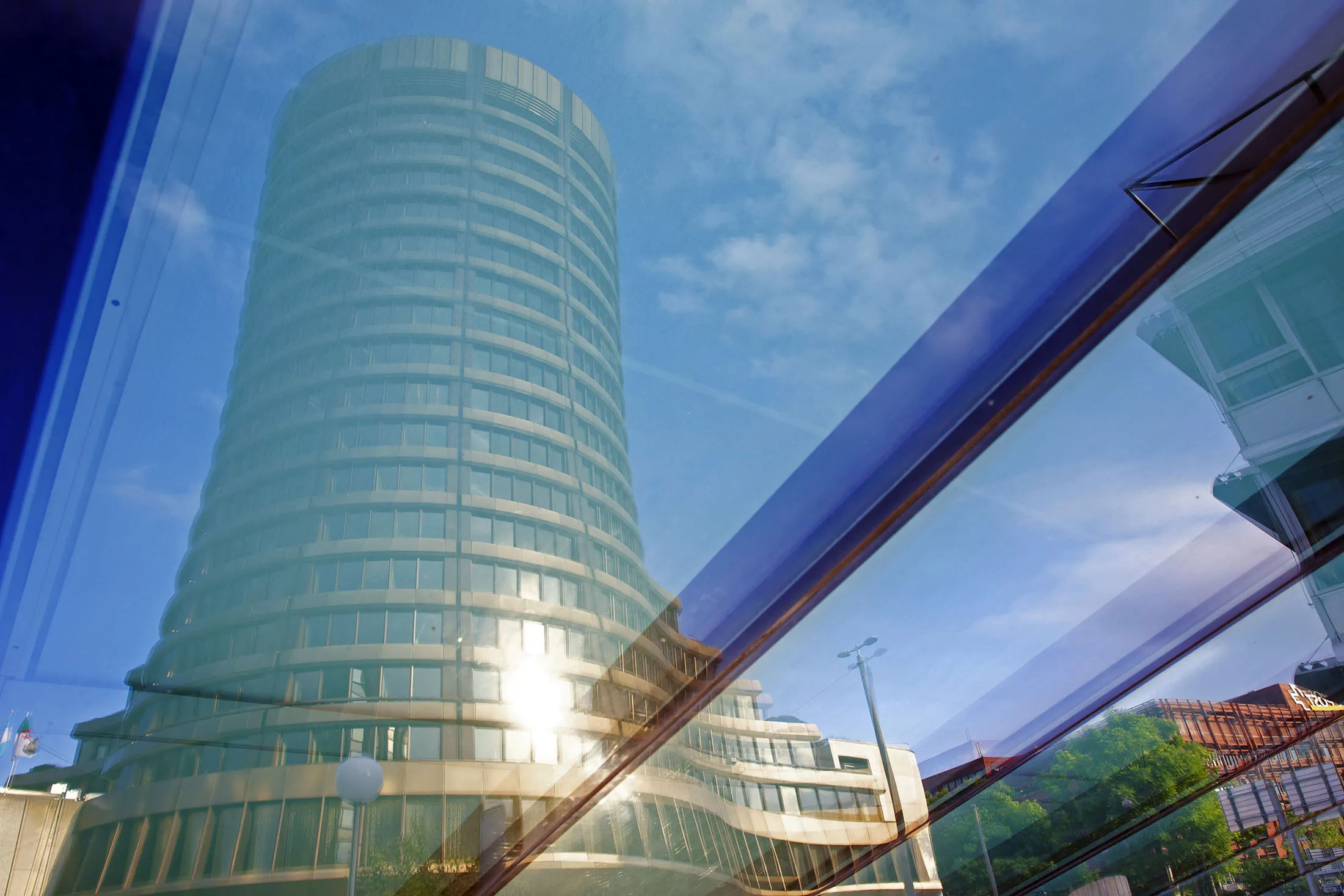 The headquarters of the Bank for International Settlements (BIS) in are reflected in a window in Basel, Switzerland.
