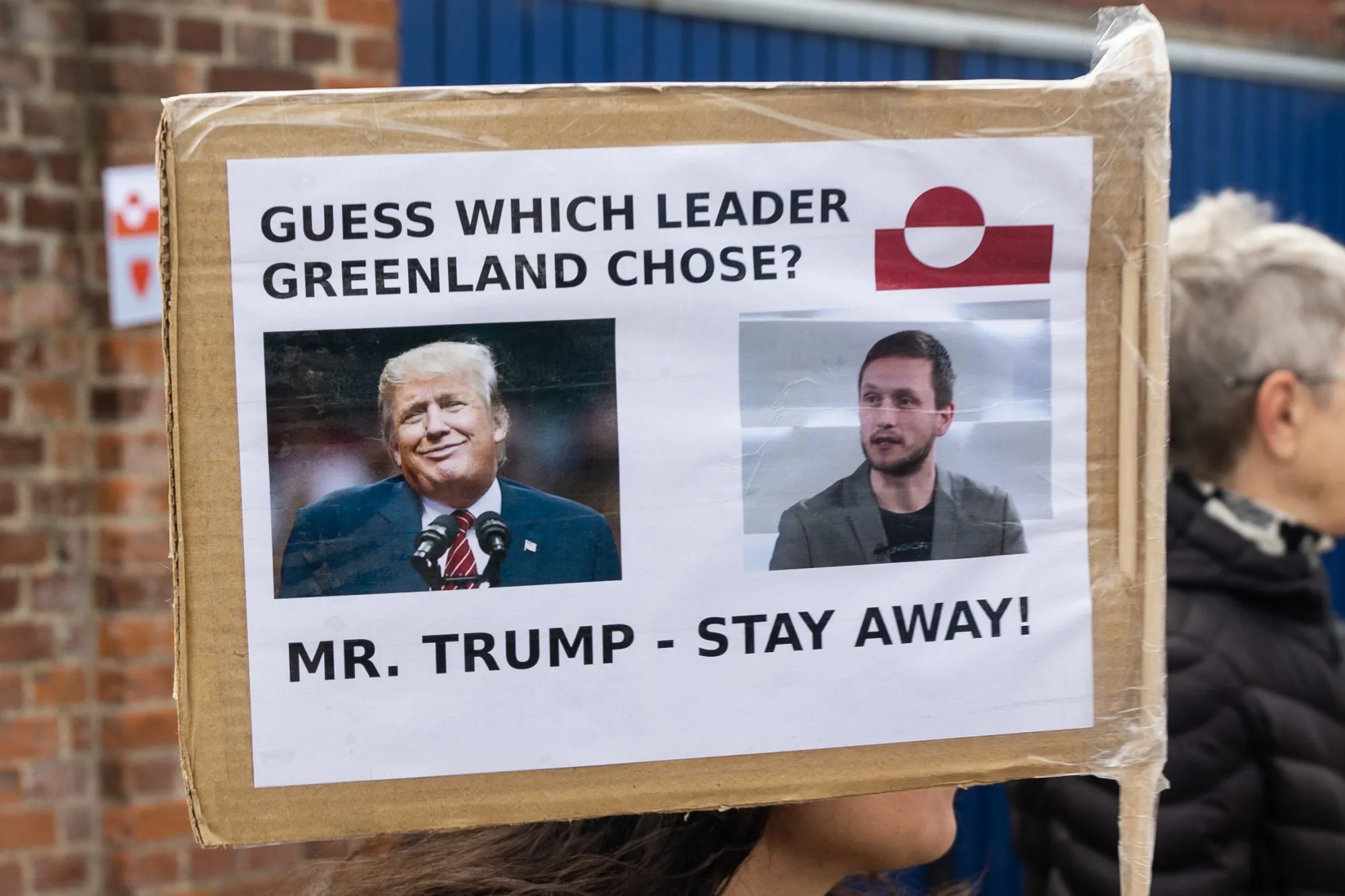 A protester holds a placard with a photo of US President Donald Trump and Greenlandic leader Jens-Frederik Nielsen&nbsp;during a demonstration against the Trump administration.