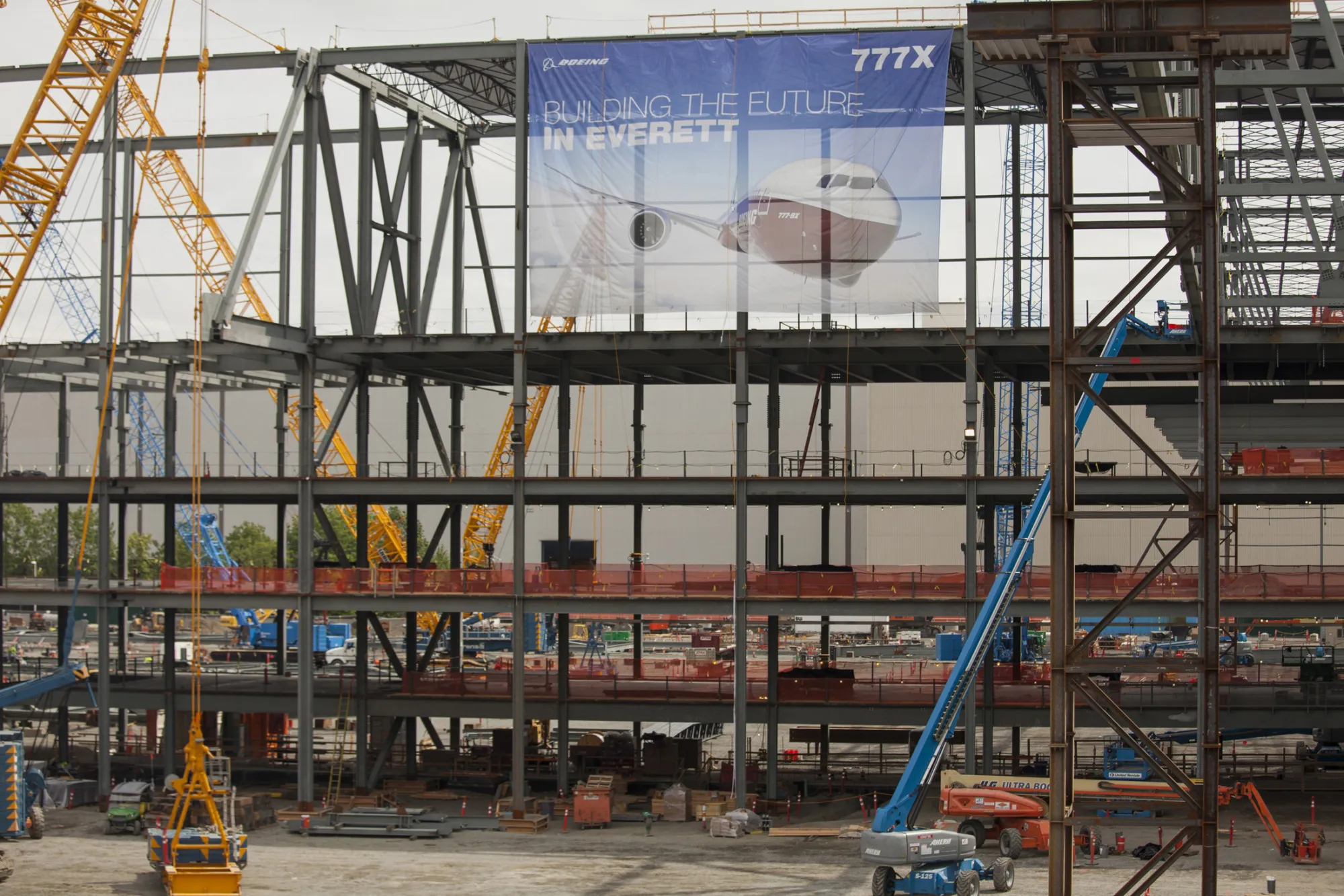 Construction cranes stand at the site of the Boeing 777X wing center facility in Everett, Washington in June 2015.
