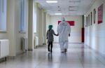 A medical worker walks with a child in a Covid-19 care unit at a hospital in Moscow, Russia.