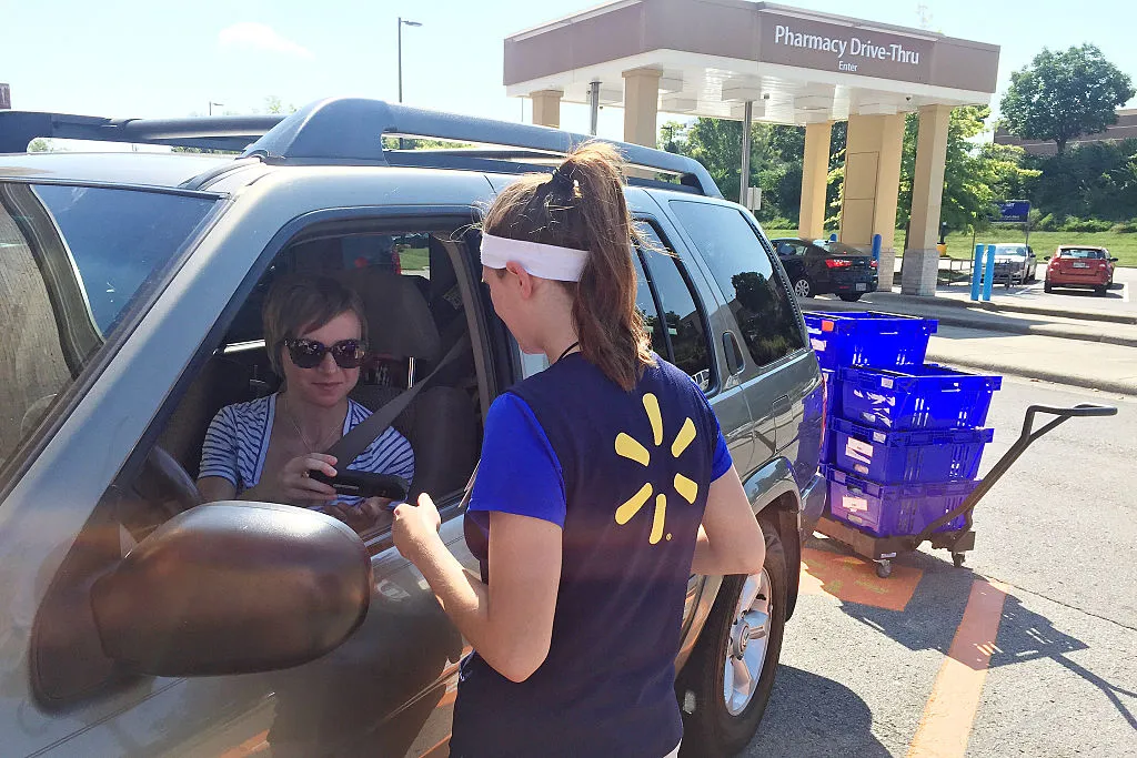 Ashley Green, 31, talks to a Walmart personal shopper as she retrieves her online grocery pickup order at the chain's Franklin, Tenn., location.
