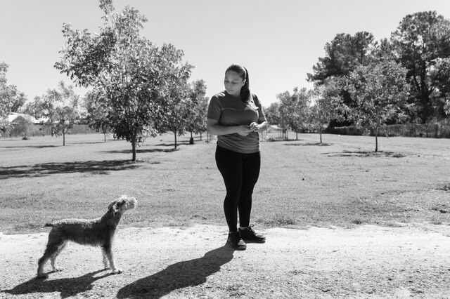 Nunez waits for her daughter outside with their dog. 