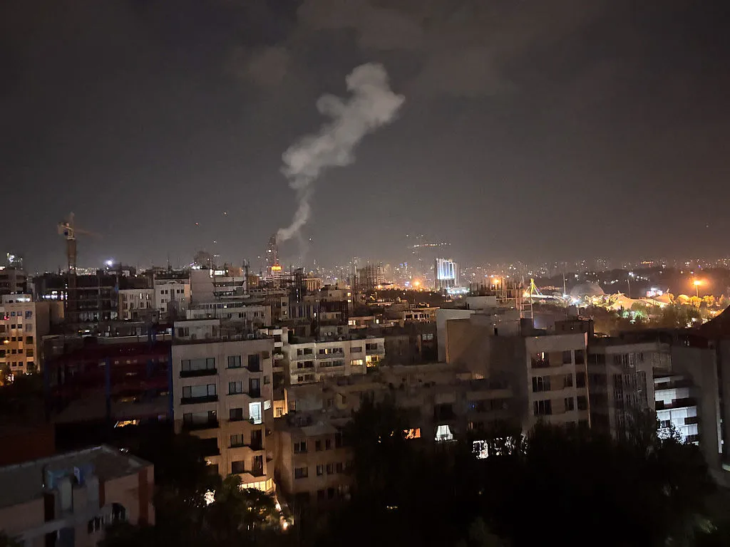 Smoke rises from a location allegedly targeted in Israel's wave of strikes on Tehran, on early morning of June 13.
