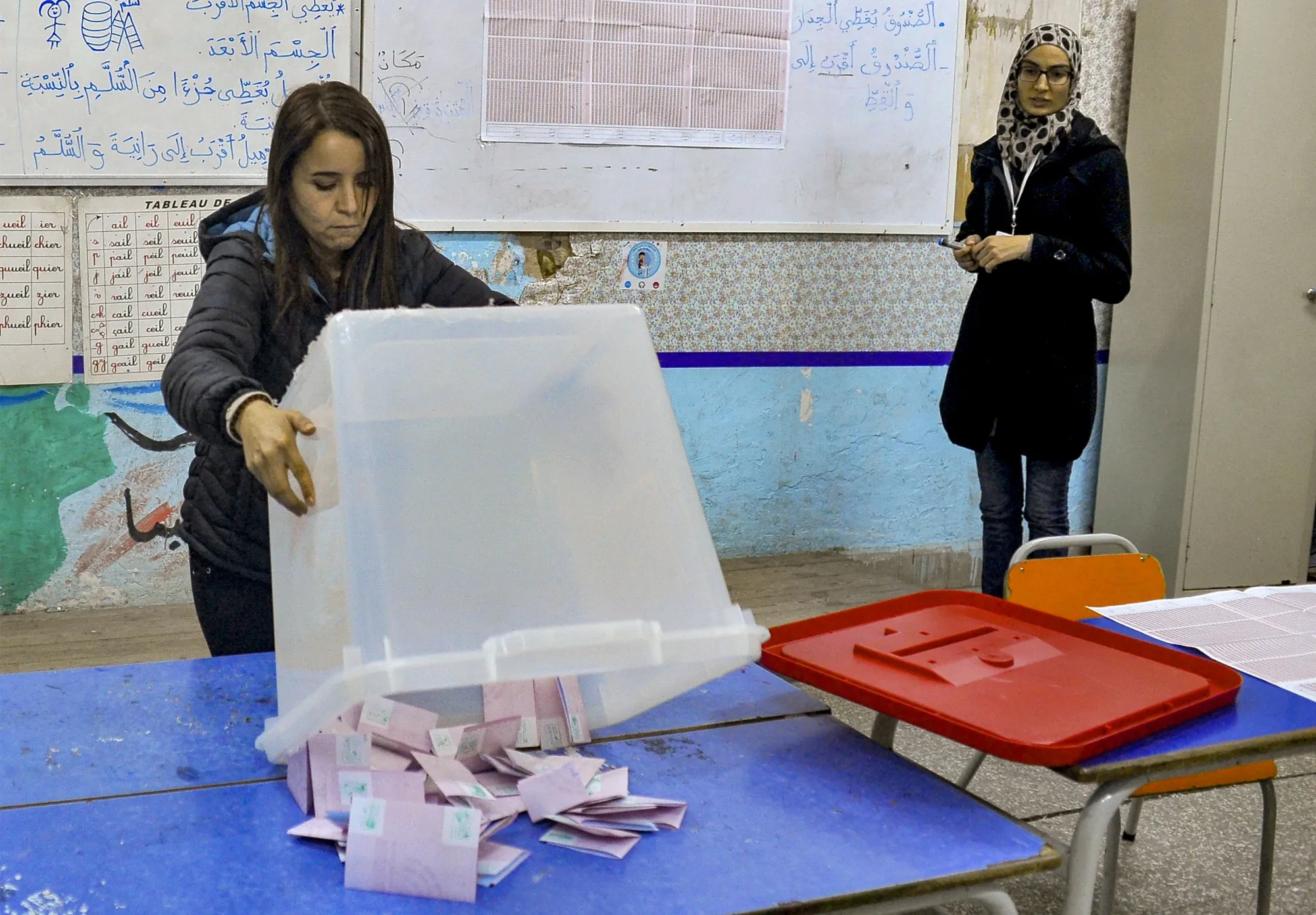 An ISIE agent begins counting ballots at a polling station in Tunis on Dec. 17.