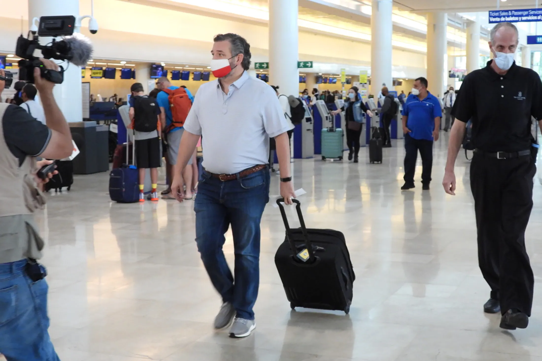 Ted Cruz arrives to check-in for a flight at Cancun International Airport, after backlash on Feb. 18. 