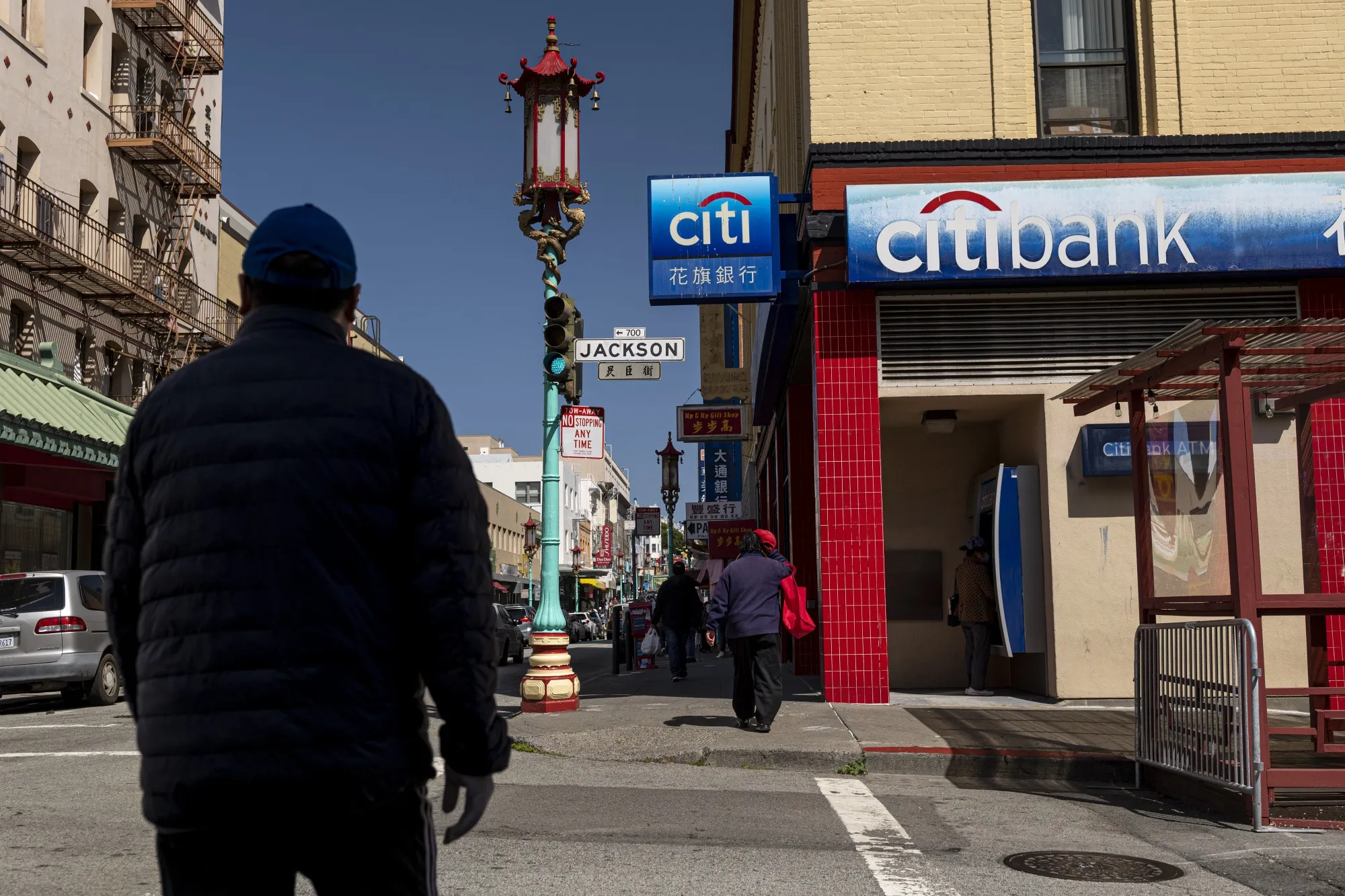 A pedestrian walks past a Citibank bank branch in San Francisco, California.