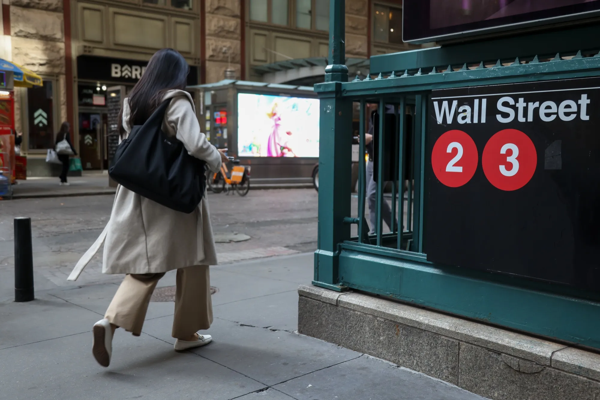 A pedestrian walks past the Wall Street subway station near the New York Stock Exchange (NYSE) in New York, US.