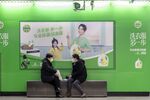 People chat at a subway station in Shanghai.