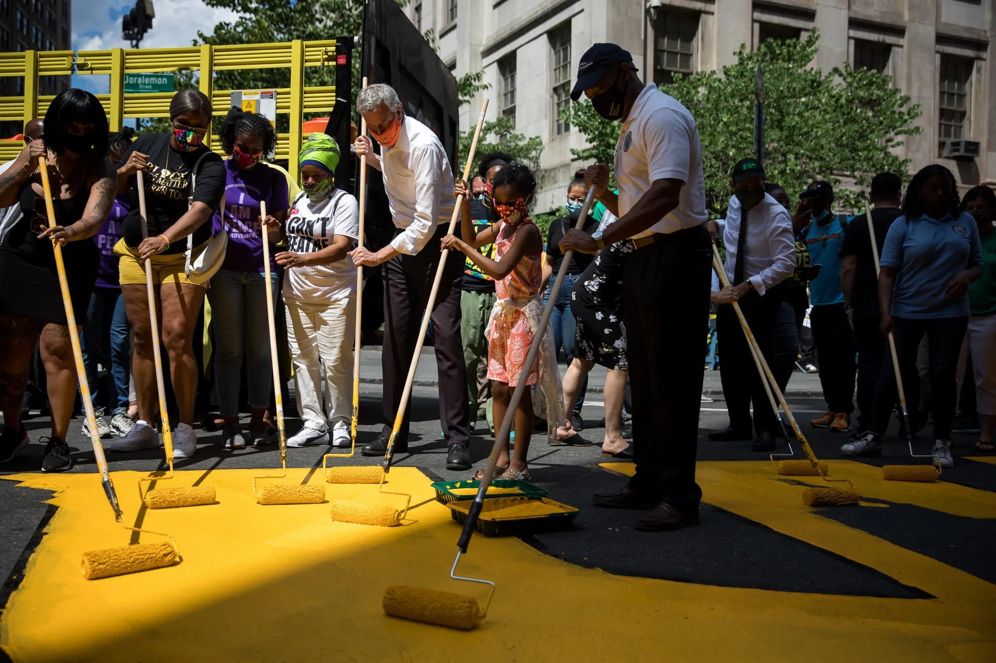 Bill de Blasio helps volunteers paint a Black Lives Matter street mural in front of Borough Hall on June 26.
