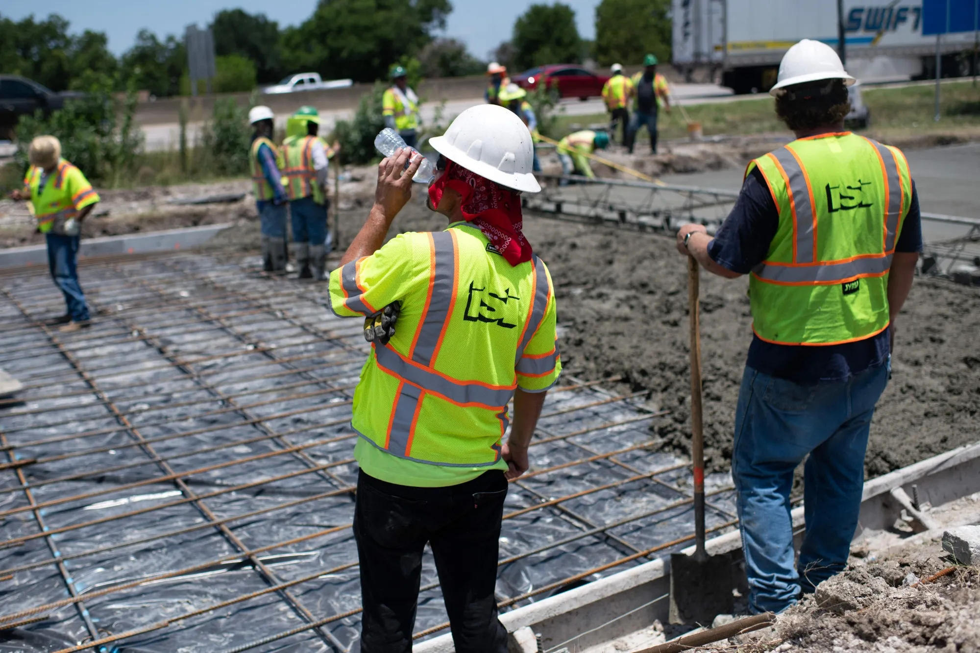 A construction worker takes a sip of water while repairing a road during a heat wave in Houston, Texas, on June 27.