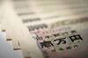 Japanese 10,000 yen banknotes are arranged for a photograph in Kawasaki, Kanagawa Prefecture, Japan, on Wednesday, Feb. 24, 2016. The yen headed for its first weekly decline since January, paring its biggest monthly advance since the global financial crisis, amid improving risk sentiment as Group-of-20 policy makers meet in Shanghai. Photograph: Akio Kon/Bloomberg