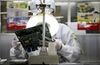 An employee works on the assembly line at Hon Hai Group's Foxconn plant in Shenzhen, Guangdong province, China, on Wednesday, May 26, 2010.