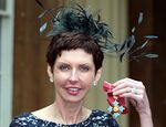 Denise Coates poses with a medal at Buckingham Palace in London, in 2012.