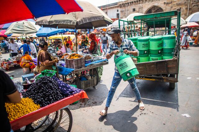 A man delivers water containers at various shops during summer days in Ahemdabad, Gujarat, India, on Friday, May 6, 2023. Photographer: Prashanth Vishwanathan/Bloomberg