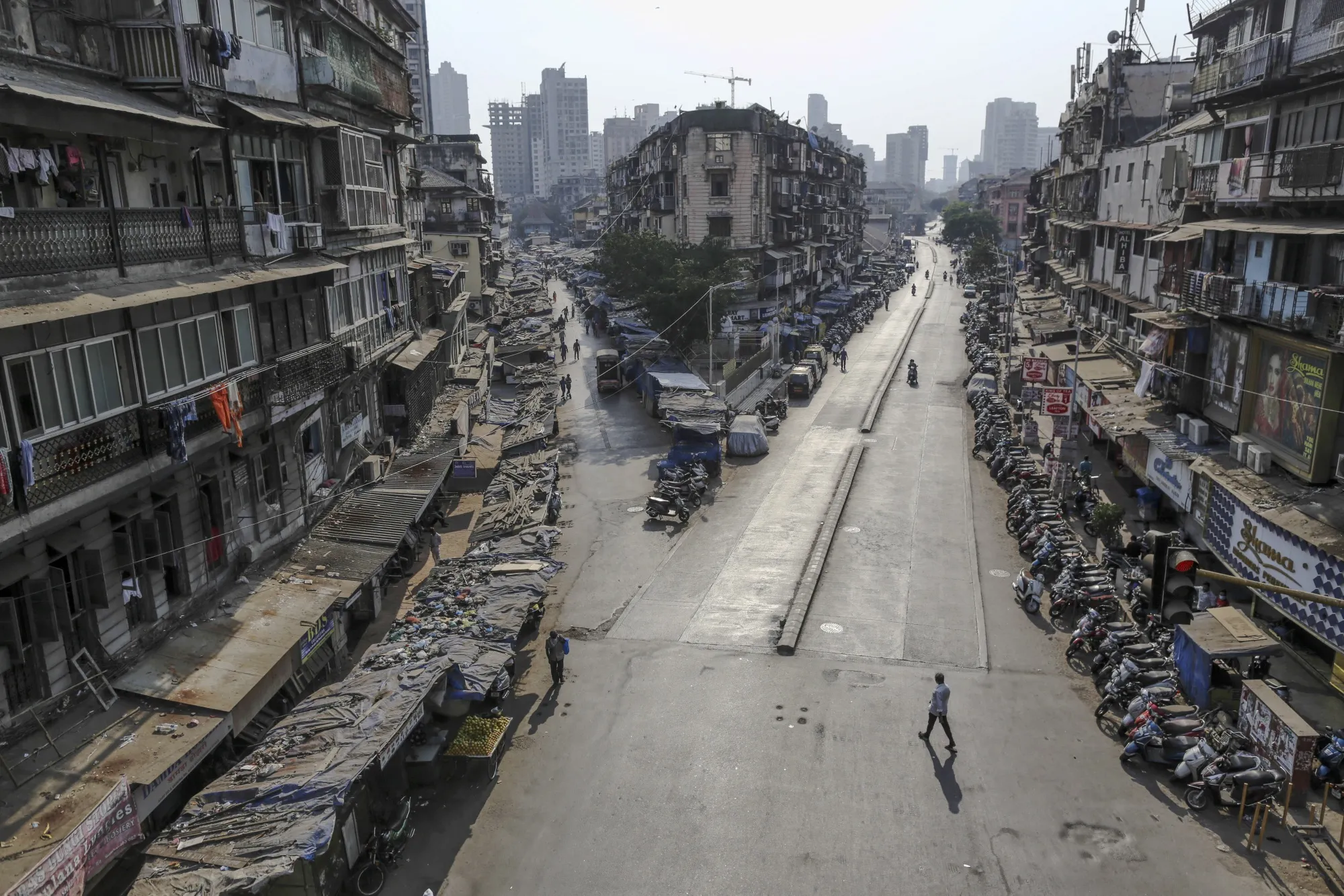 Pedestrians walk along near-empty roads during a lockdown imposed&nbsp;in Mumbai, March 2020.&nbsp;