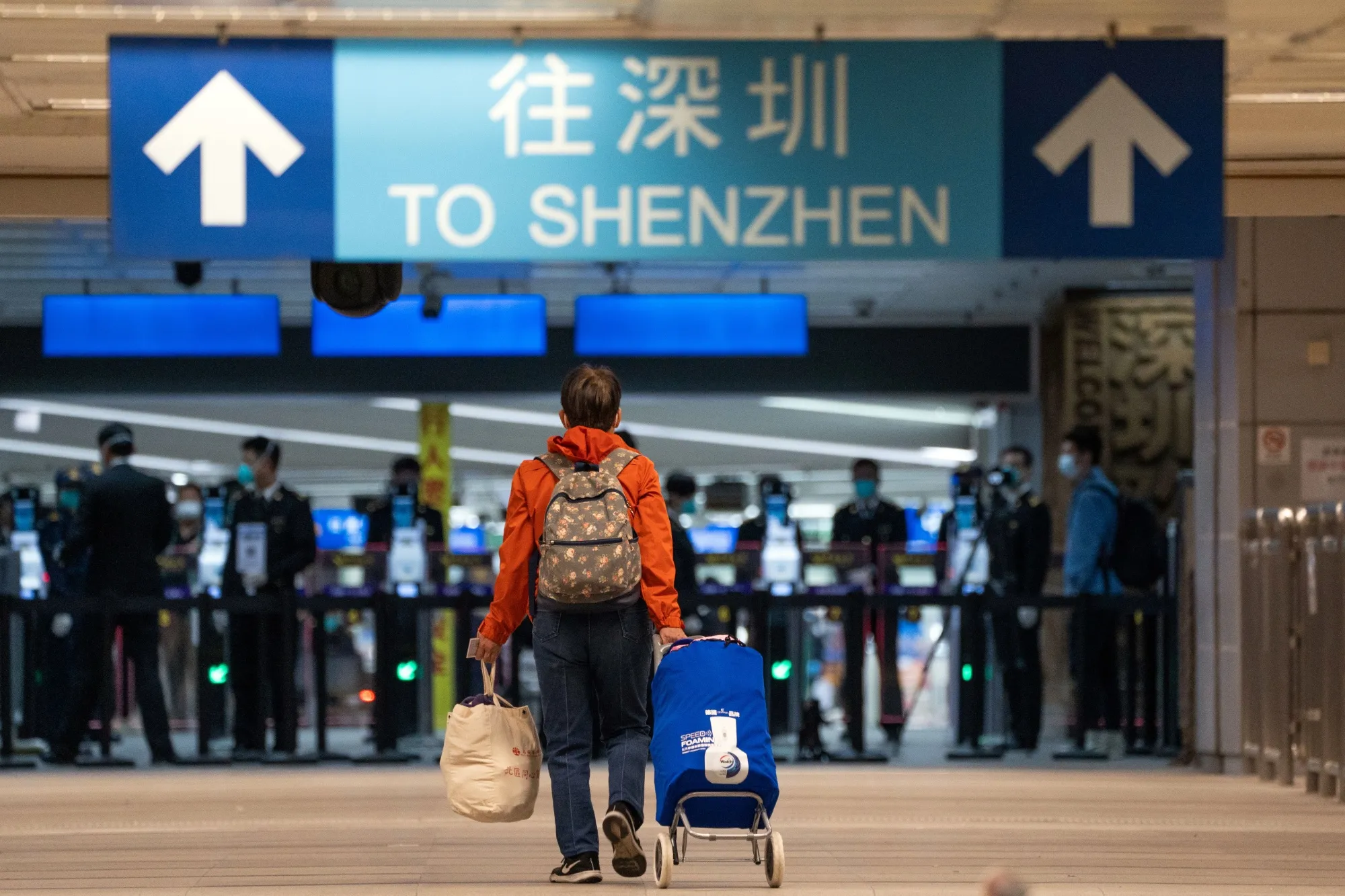 A traveler walks towards Shenzhen in the border control area at Lo Wu station in Hong Kong, on Feb. 6.