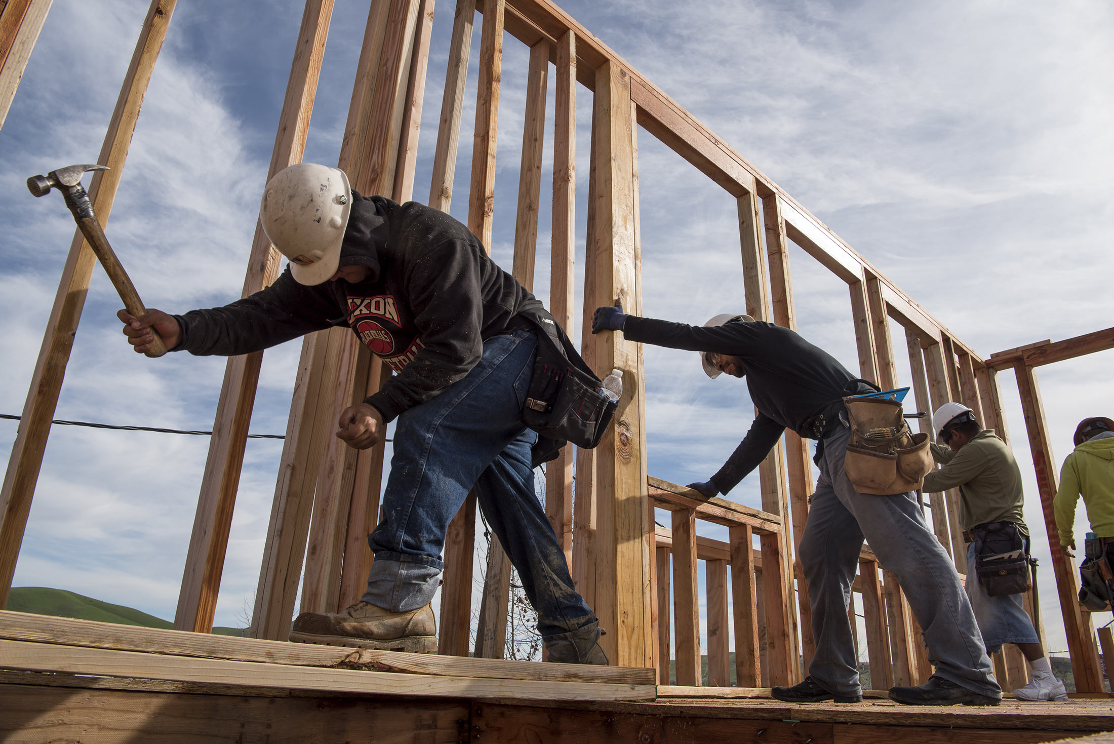Contractors secure a wall section on a home under construction at the Toll Brothers Inc. Cantera at Gale Ranch housing development in San Ramon, California, U.S., on Wednesday, Jan. 20, 2016. The U.S. Census Bureau reported a drop in new-home construction for December which probably reflects little more than a pause in a steady uptrend, as housing starts closed out the strongest year since 2007.
