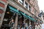 Pedestrians pass in front of a Dean & DeLuca store in the Soho neighborhood of New York on July 17.
