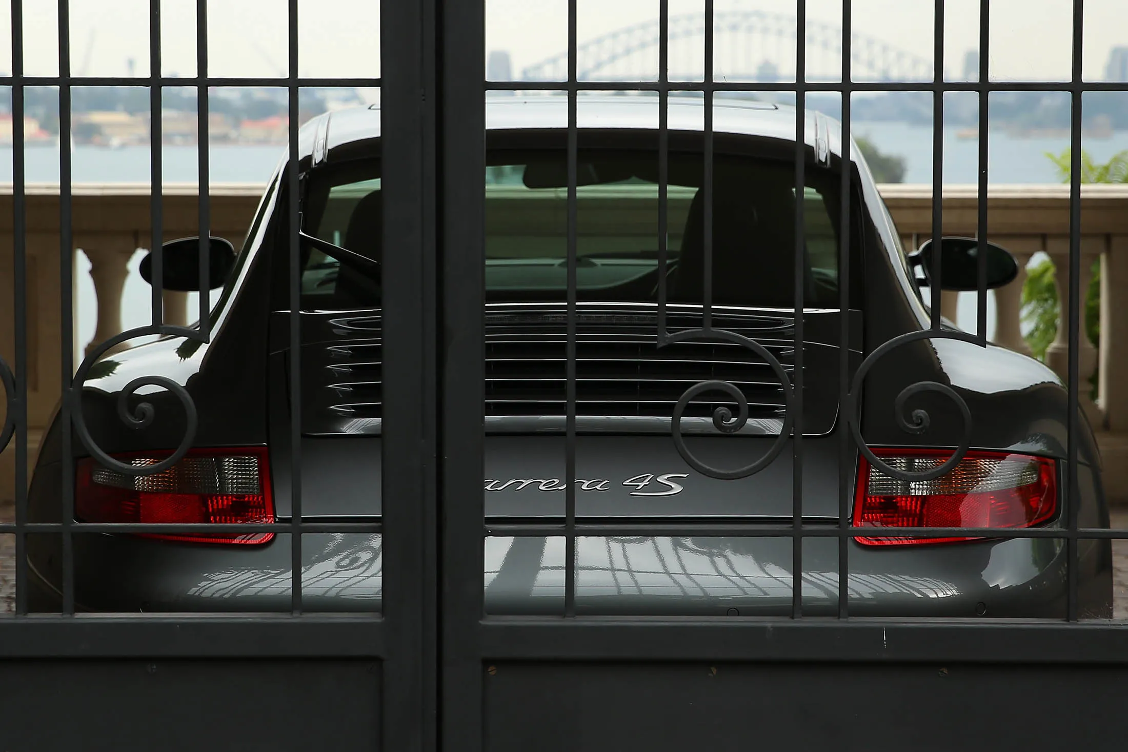 A Porsche 911 Carrera 4S sits parked at a residential property in the suburb of Point Piper in Sydney, Australia, on Tuesday, March 10, 2015. Foreigners who illegally buy homes in Australia will face higher fines and be forced to sell the property under rules proposed last month by Prime Minister Tony Abbott's government.
