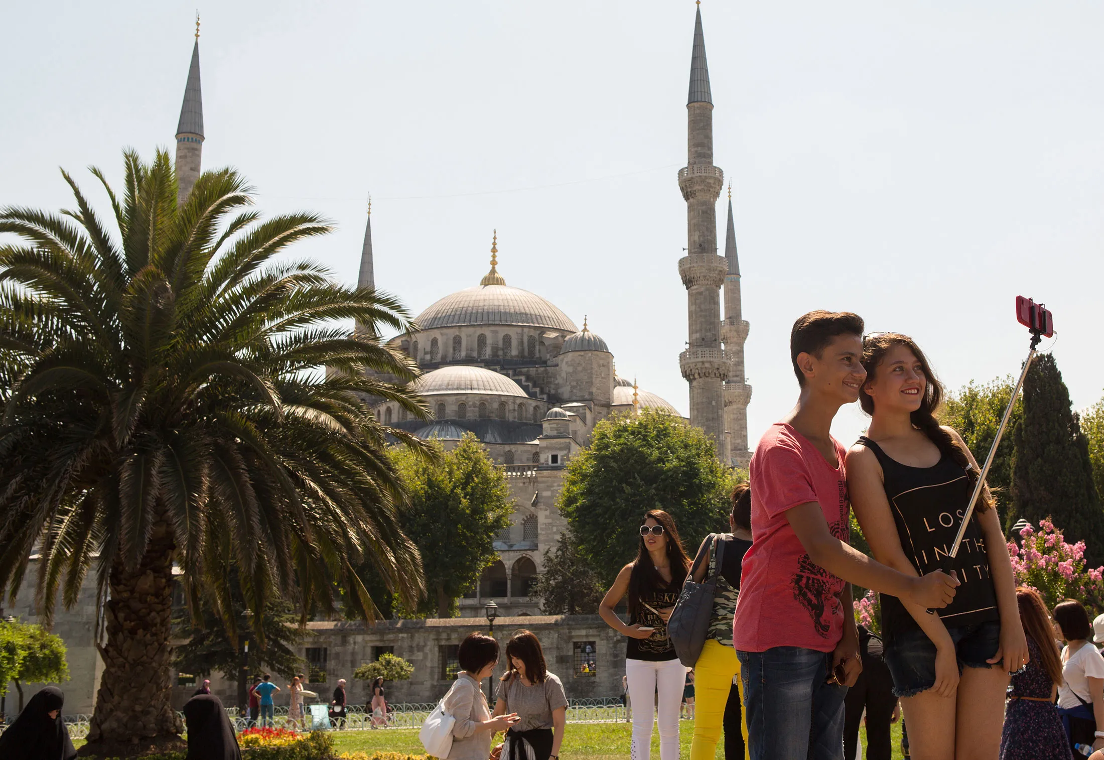 Tourists at the Sultan Ahmet Mosque in the Fatih district of Istanbul, Turkey.
