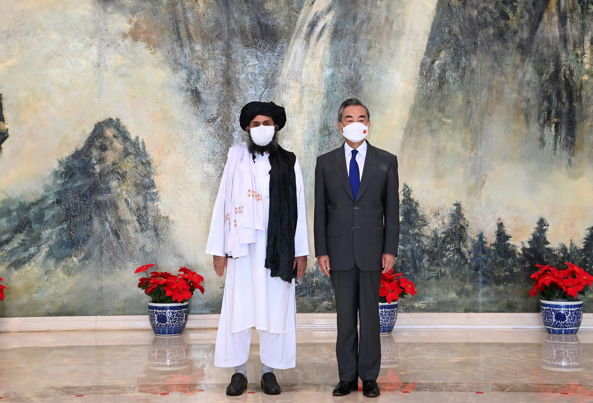 Wang Yi, right, with Mullah Abdul Ghani Baradar, in north China’s Tianjin, on July 28.