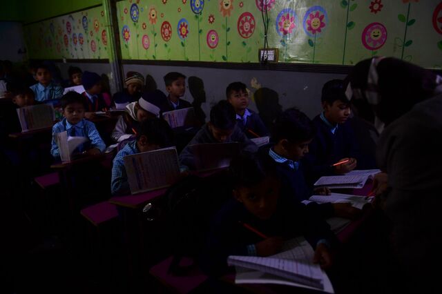 Students attend a class at a private school during a nationwide power outage in Karachi, Pakistan
