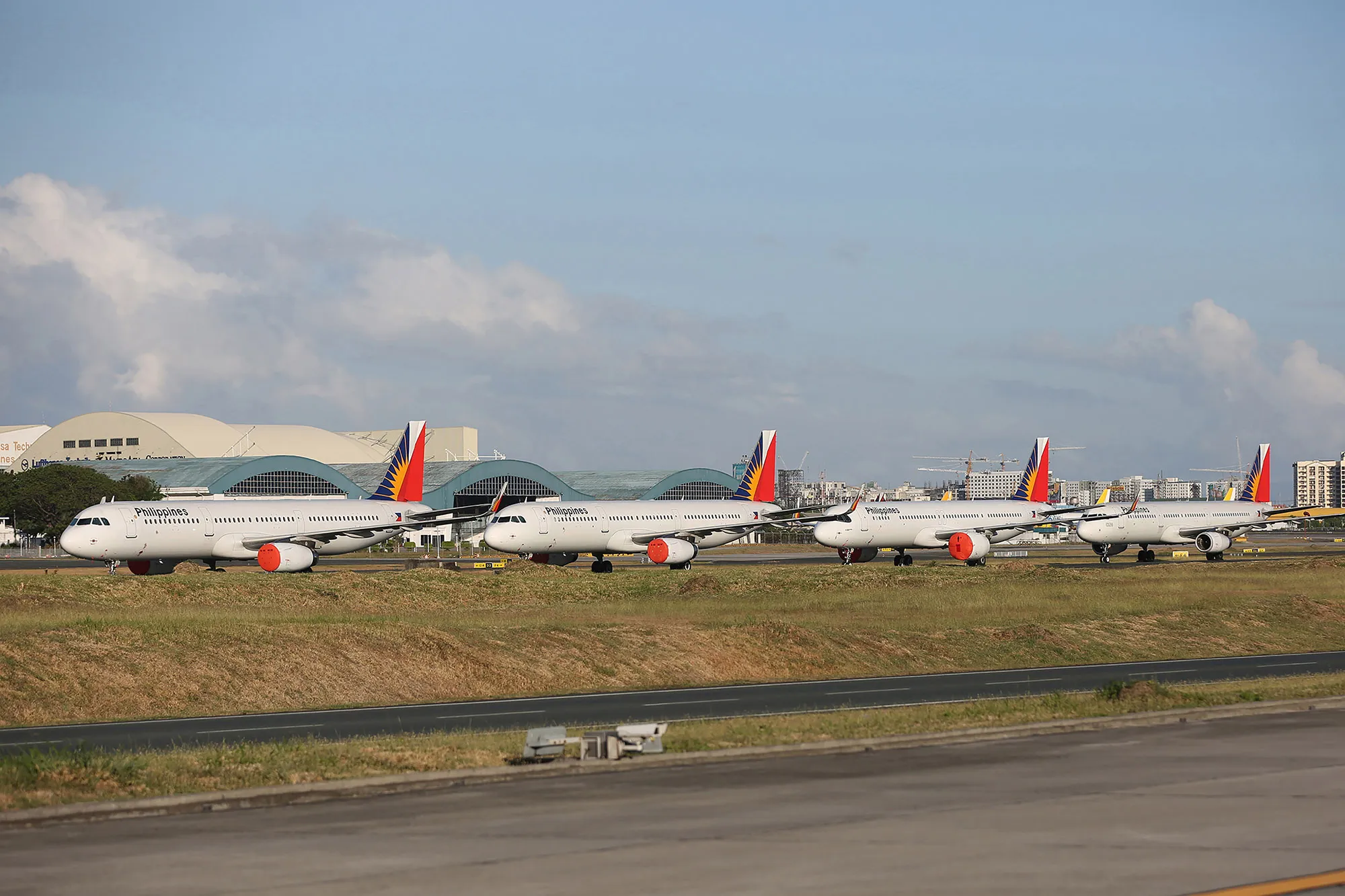 Philippine Airlines aircraft parked on the tarmac of Manila international airport.