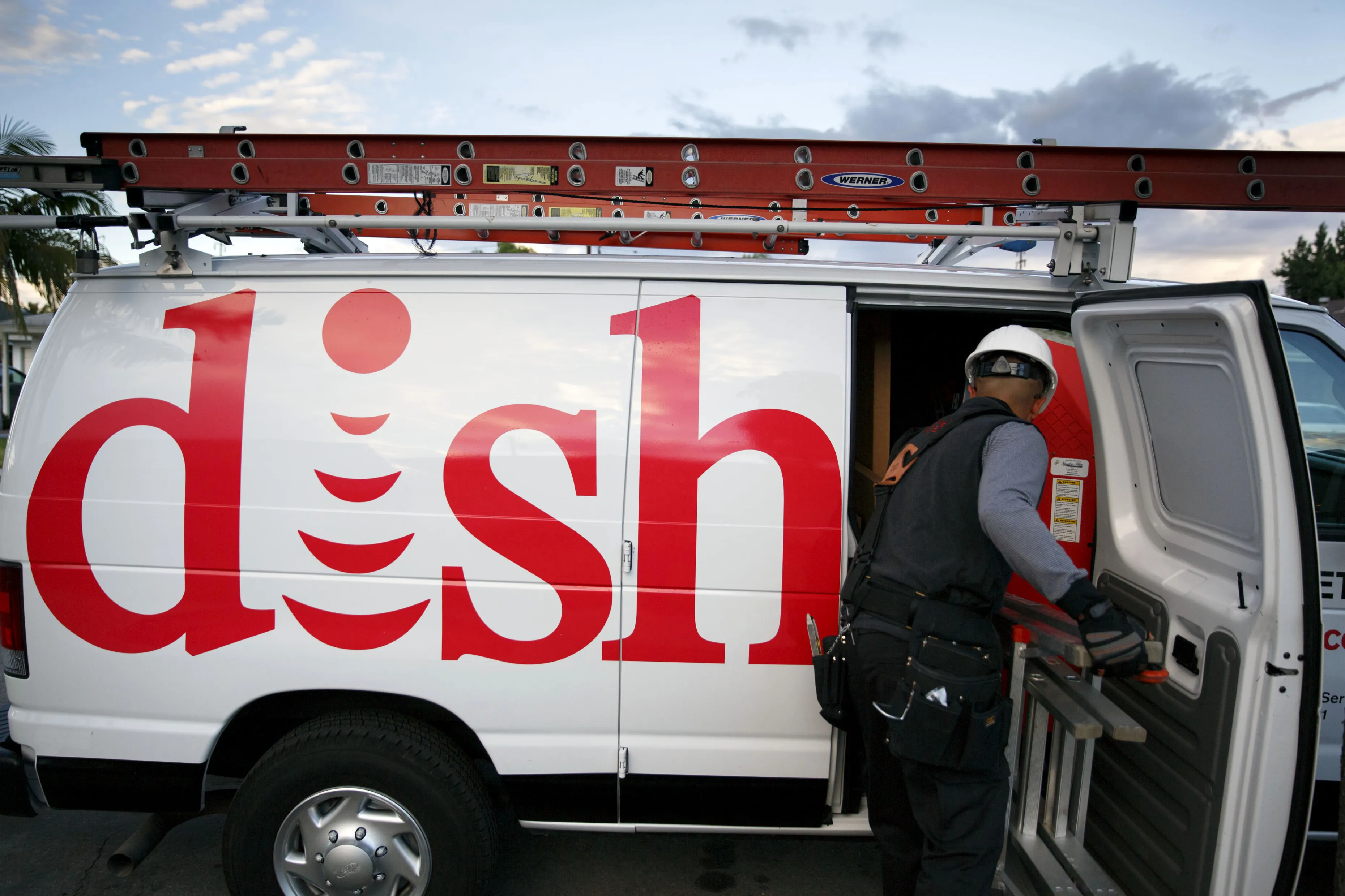 A Dish Network Corp. field service specialist installs a satellite television system at a residence in Downey, California.