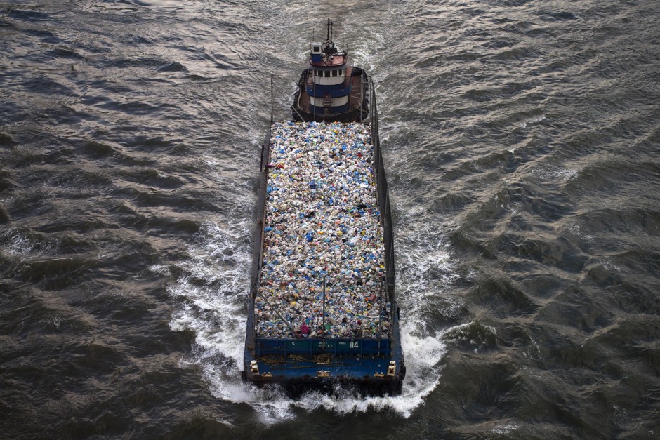A barge carries recyclable waste along the East River near Manhattan, New York June 24, 2013. 