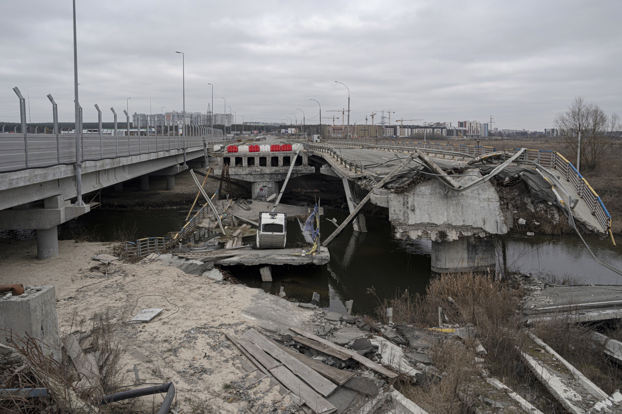 The new&nbsp;Irpin Bridge, left, next to the destroyed former bridge on March&nbsp;7.