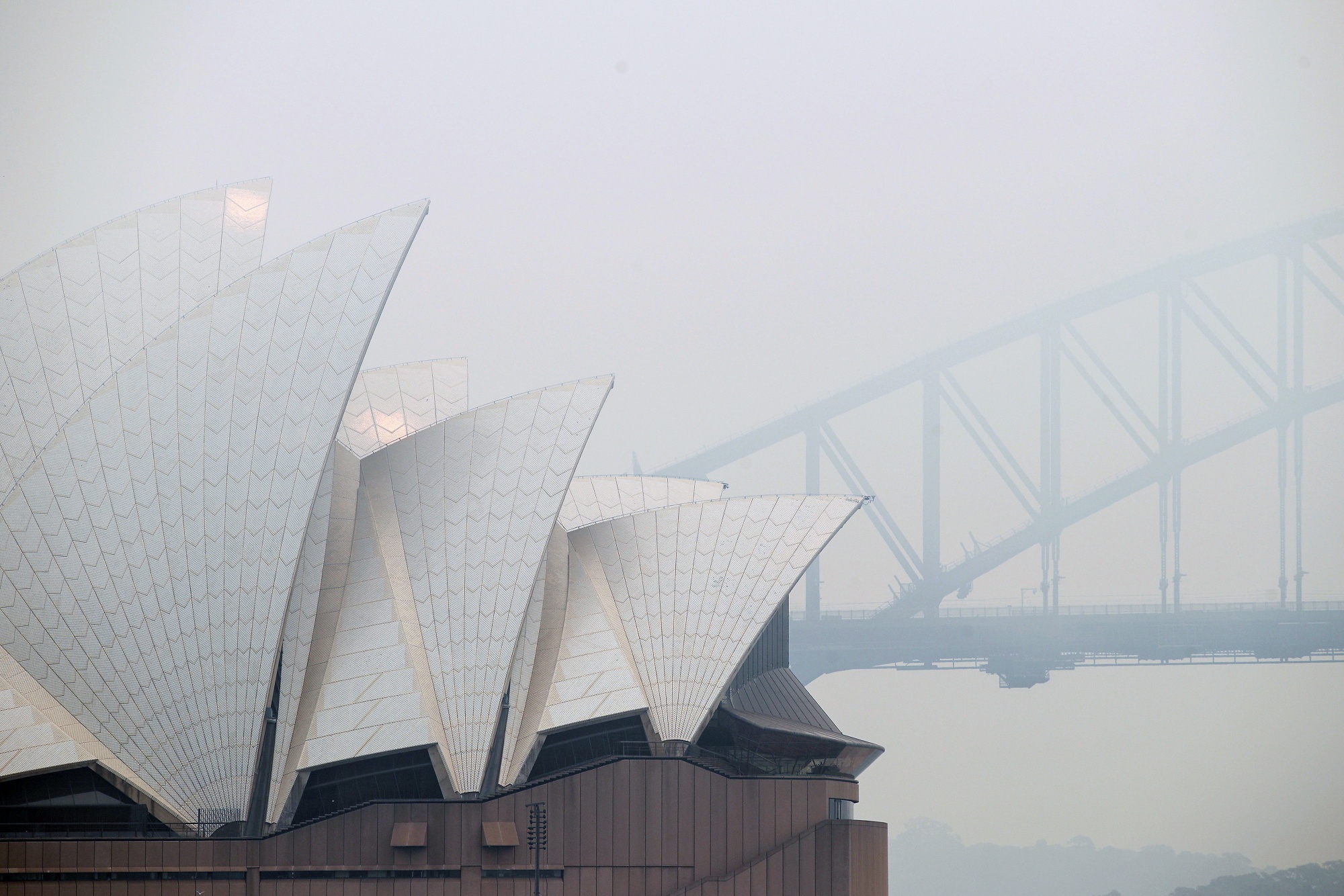The Sydney Opera House and Sydney Harbour Bridge shrouded in haze from bushfires, in Sydney, Australia, in Dec. 2019.