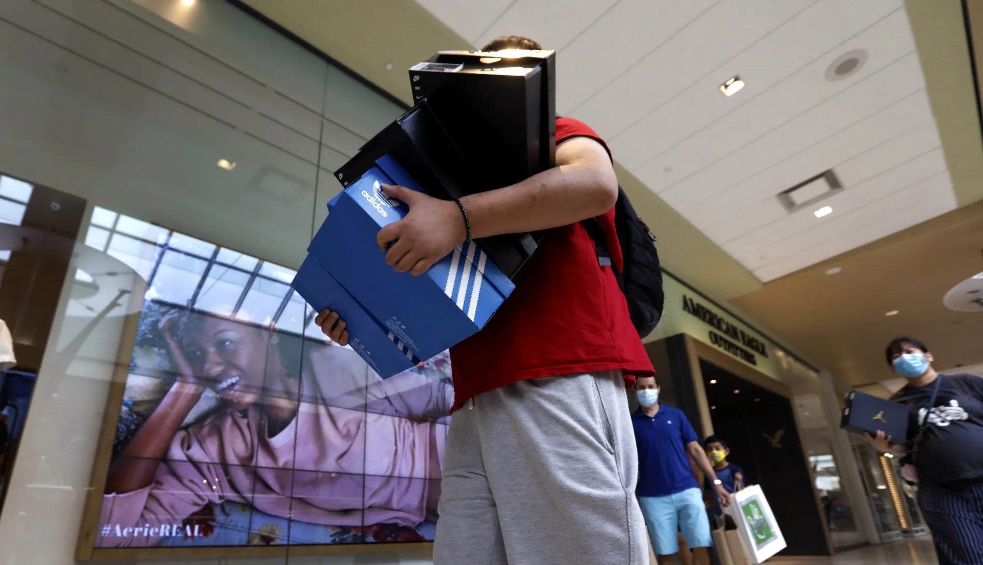A shopper carries boxes of shoes at a&nbsp;mall in&nbsp;Queens,&nbsp;New York.