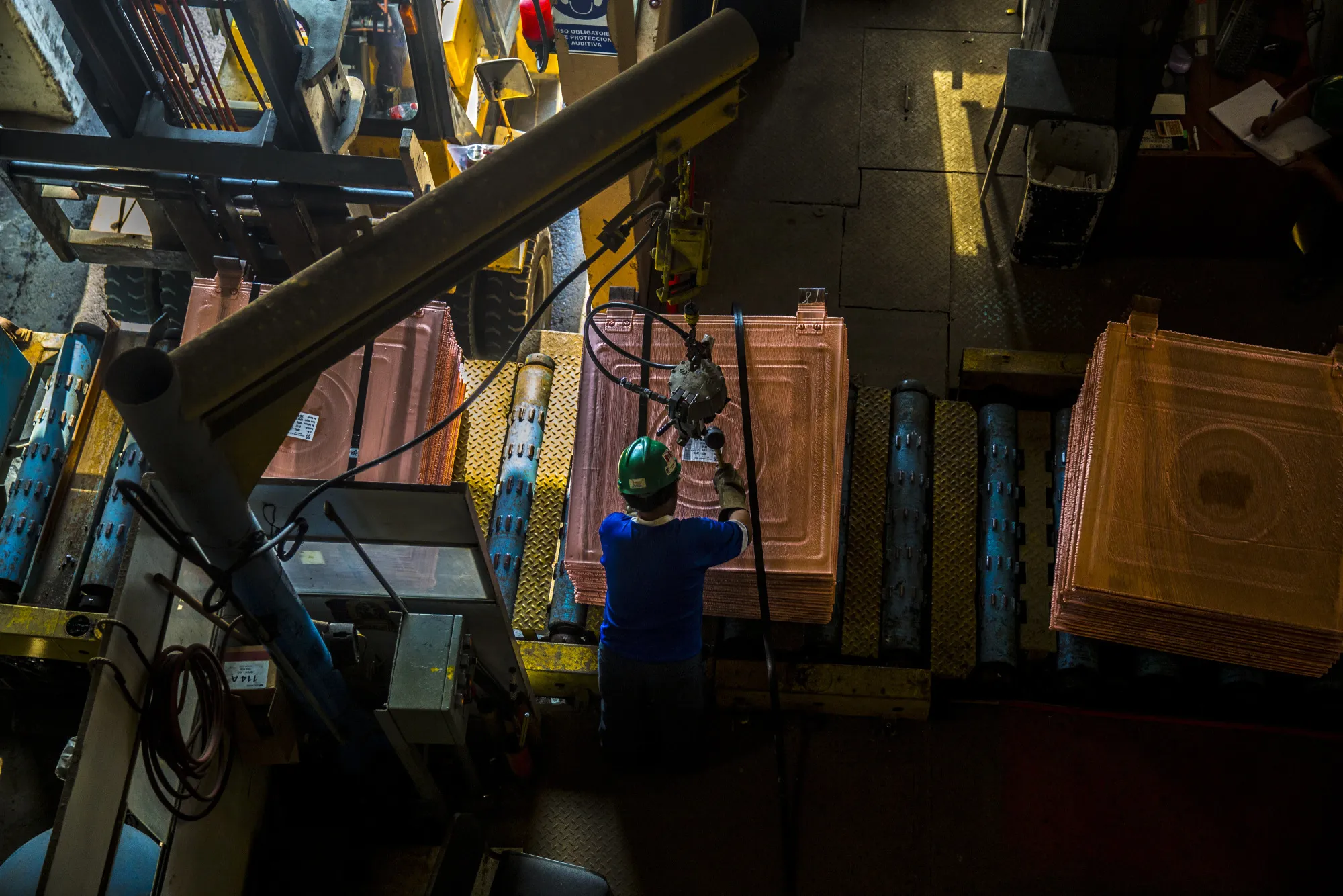 An employee seals and packages copper plates at a copper refinery in Ilo, Peru.