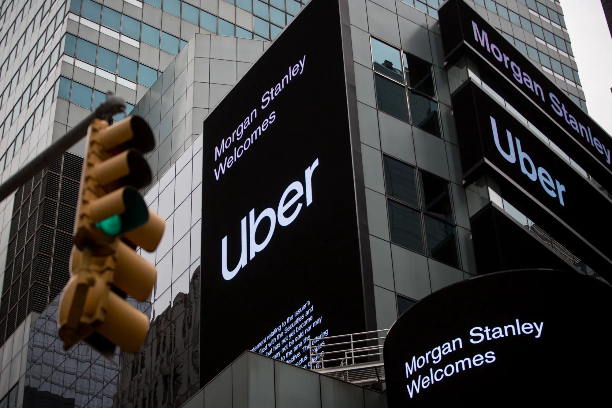Monitors display Uber Technologies Inc. signage in front of Morgan Stanley headquarters in the Times Square area of New York.