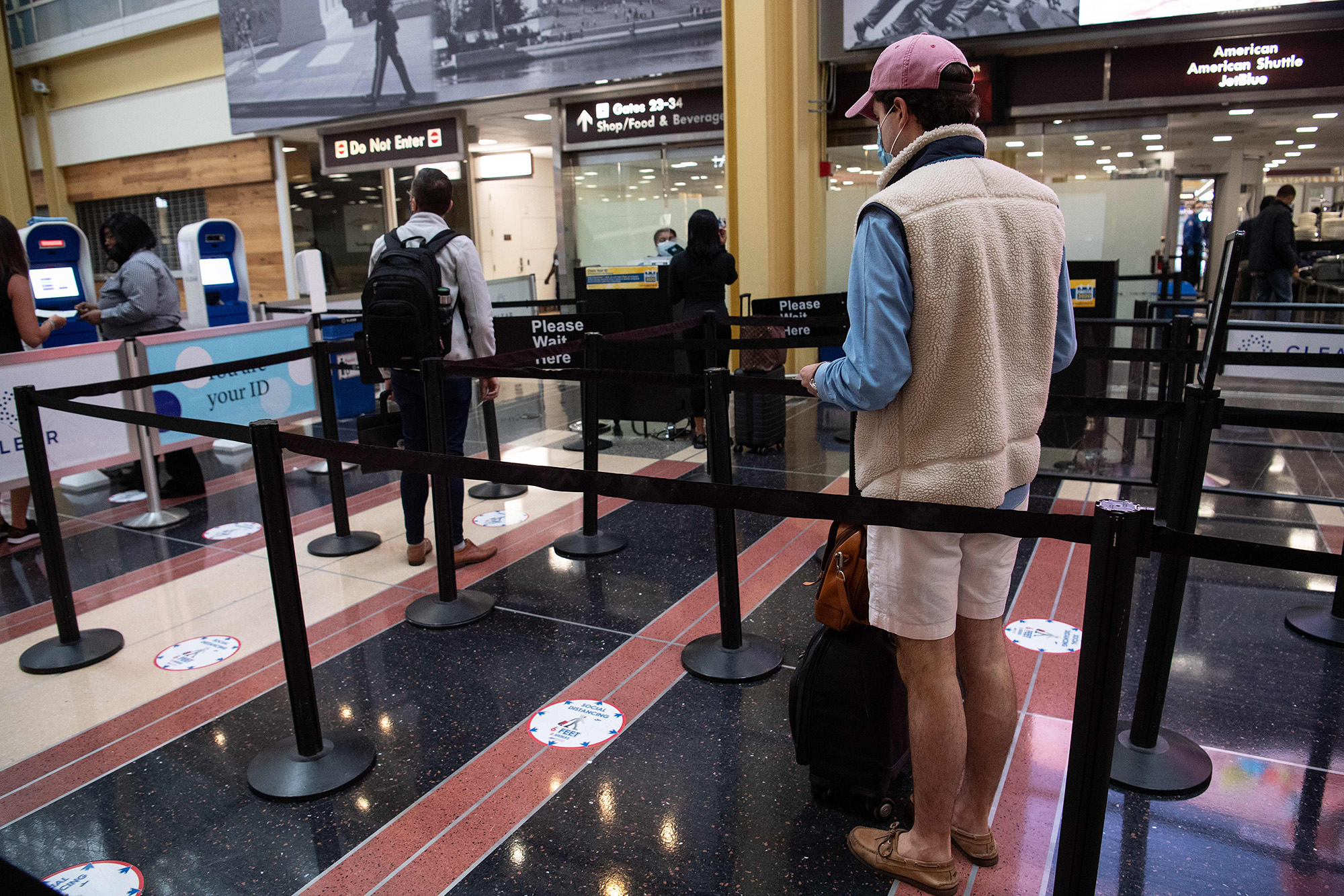 People wait in line at a security checkpoint at Reagan National Airport in Arlington, Virginia on May 22.