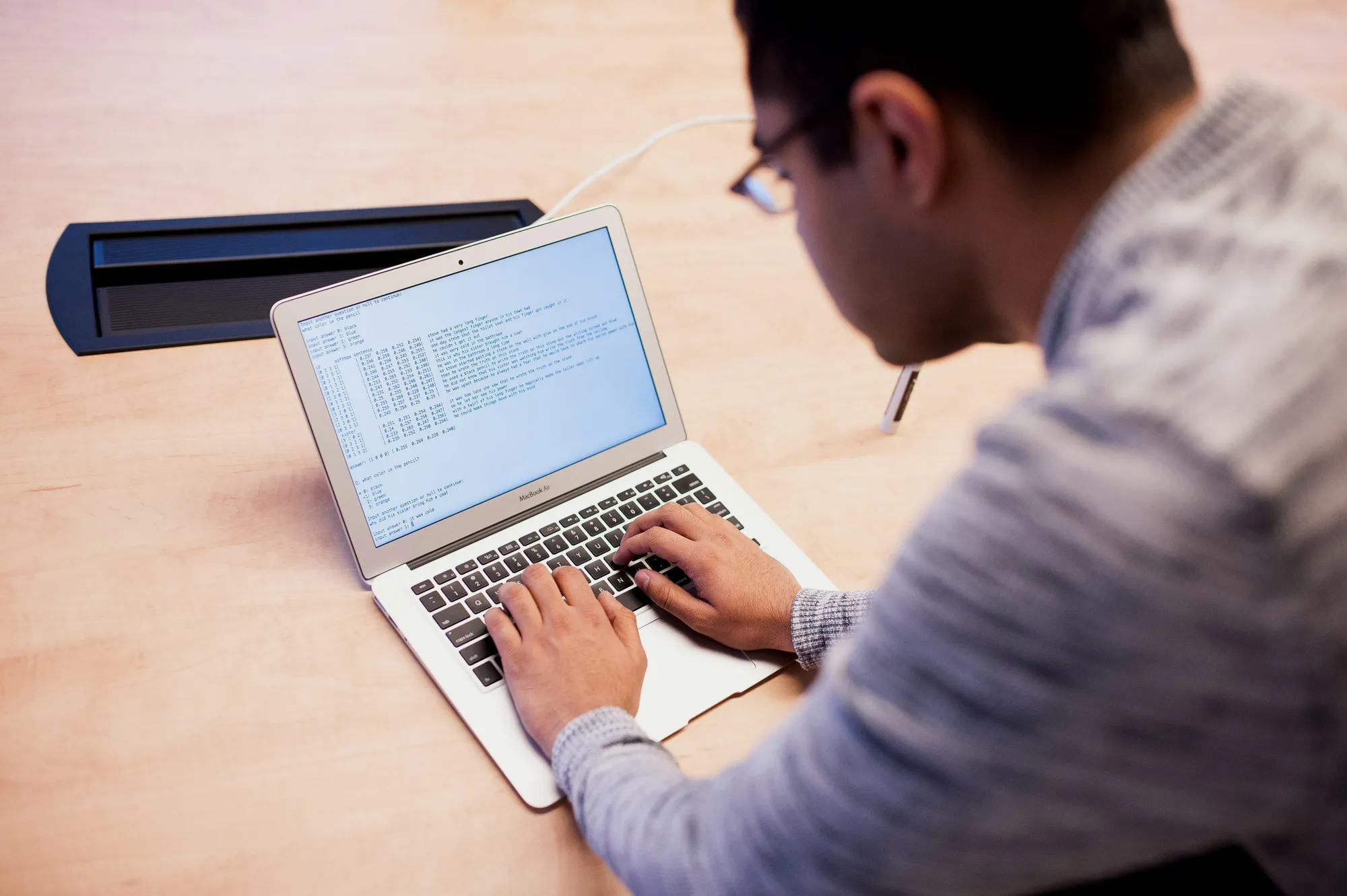 A worker types questions into a&nbsp;program used to test and develop&nbsp;artificial intelligence&nbsp;programs.
