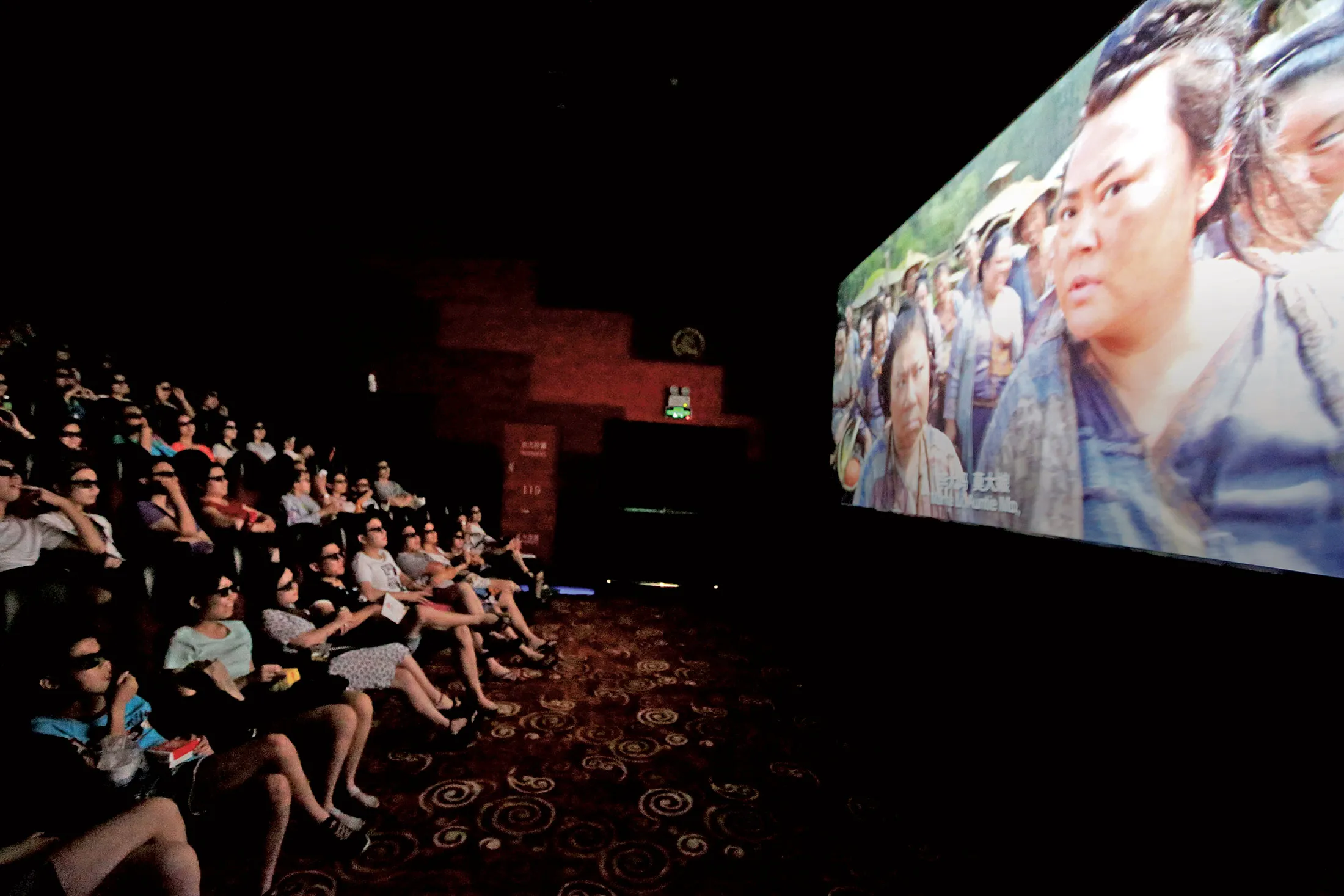 Chinese filmgoers wearing 3D glasses watch Monster Hunt in Shanghai on July 26.
