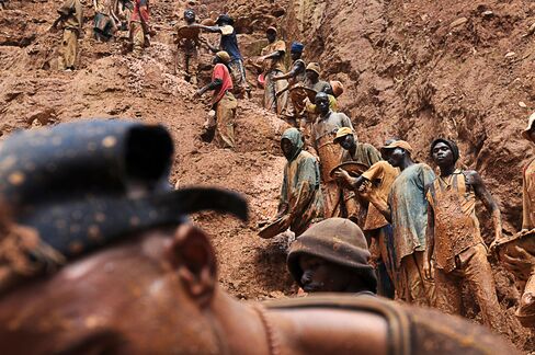 Men work in an open pit gold mine in Chudja, Congo.