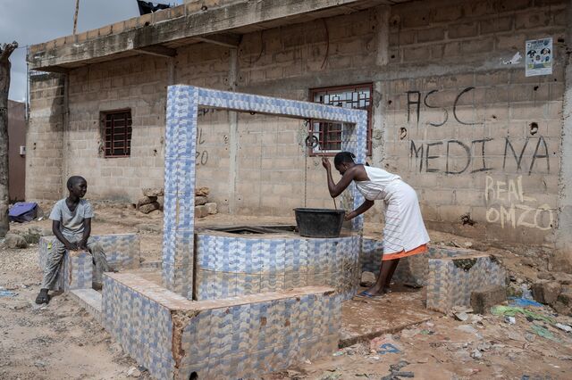 A woman draws water from a well in Dakar’s Tivaouane Peulh neighborhood on Aug. 31.