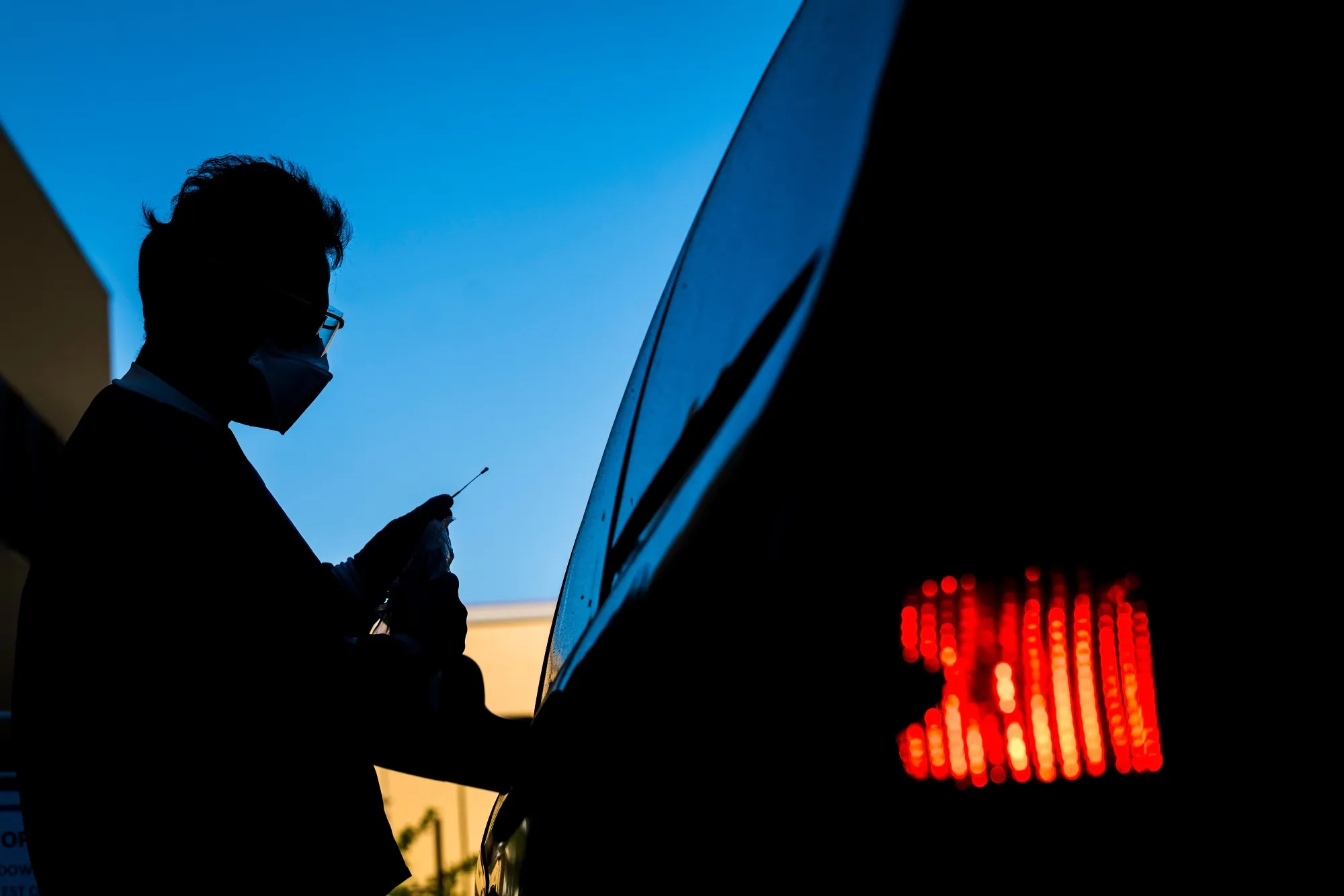 A medical personnel administers a swab test at a drive-thru testing site in San Pablo, California on April 28.