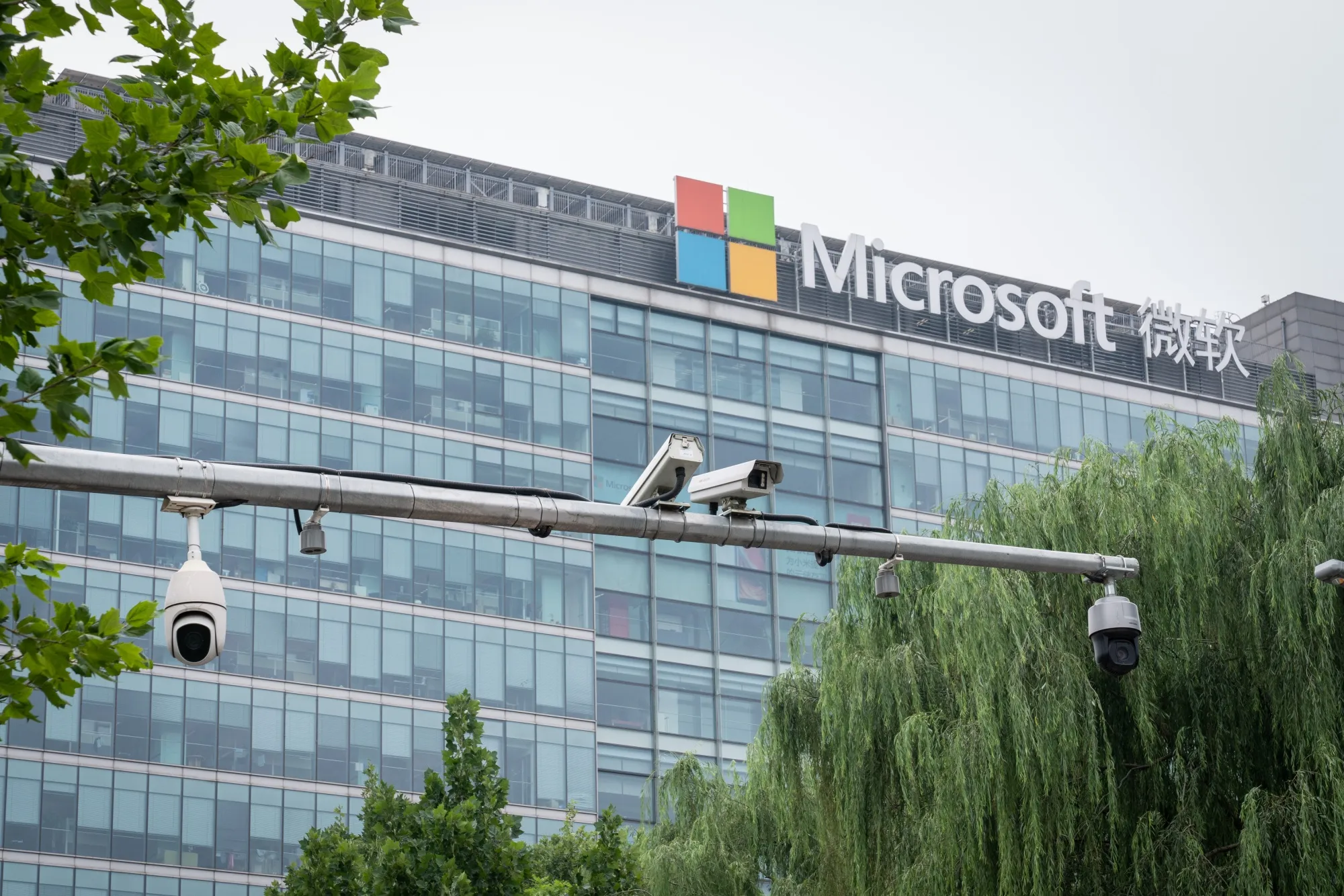 Surveillance cameras are mounted on a post in front of Microsoft Corp. office building in Beijing, China on July 16, 2021.