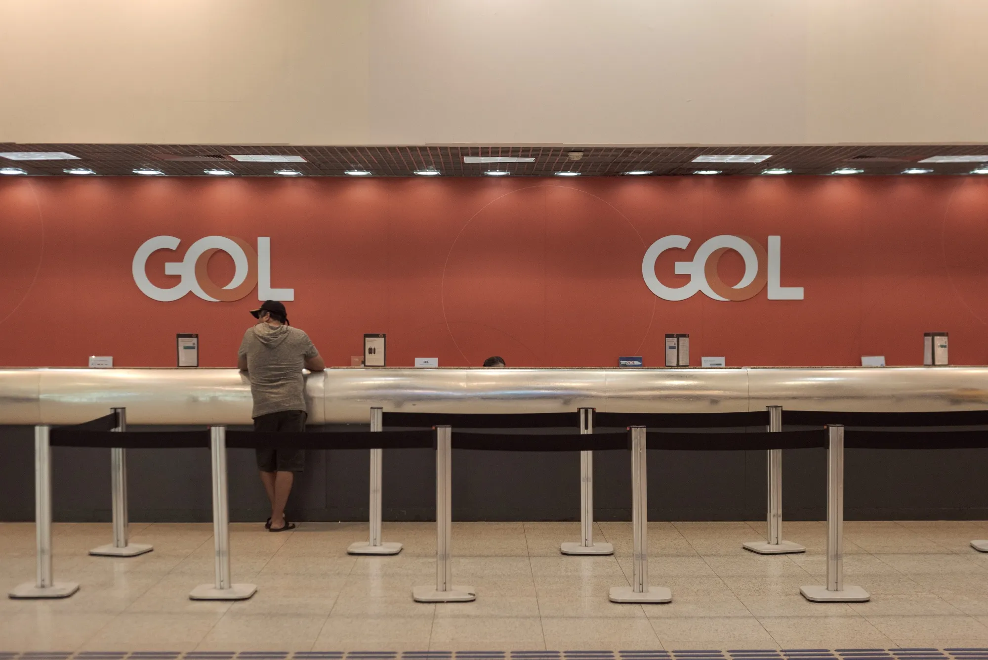 A traveler checks in at the Gol Airlines ticket counter at Santos Dumont Airport in Rio de Janeiro, Brazil.