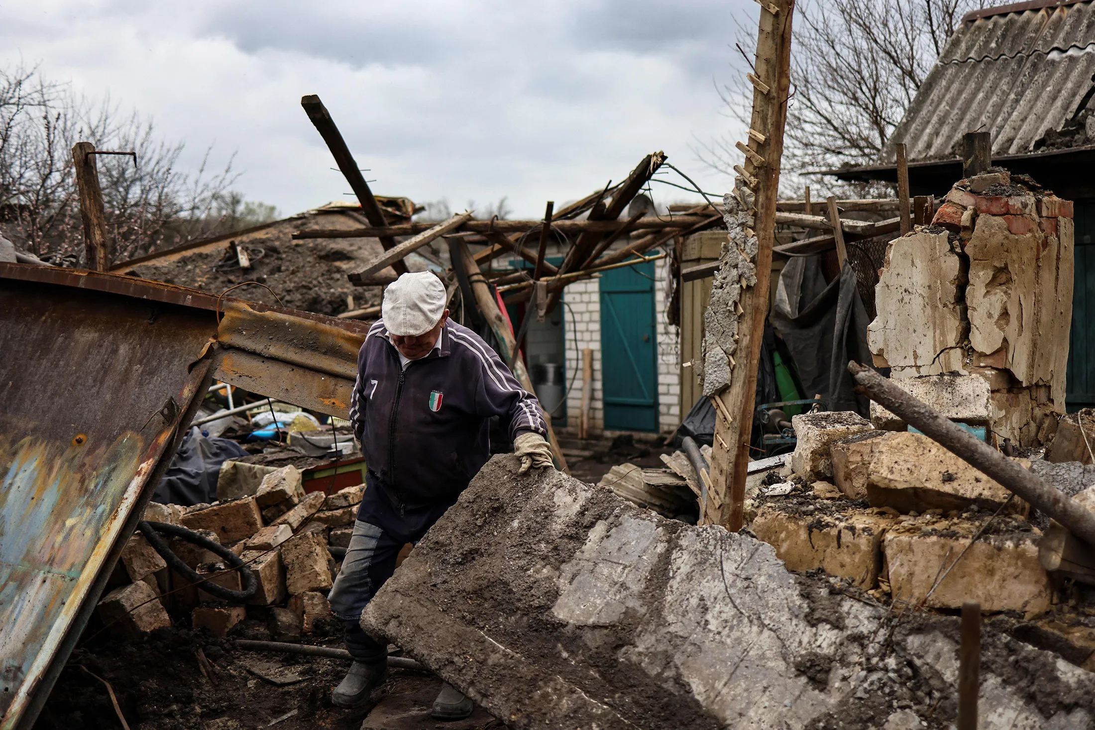 A resident walks through the debris of a destroyed house in Novodruzhesk village, Ukraine, on April 18.