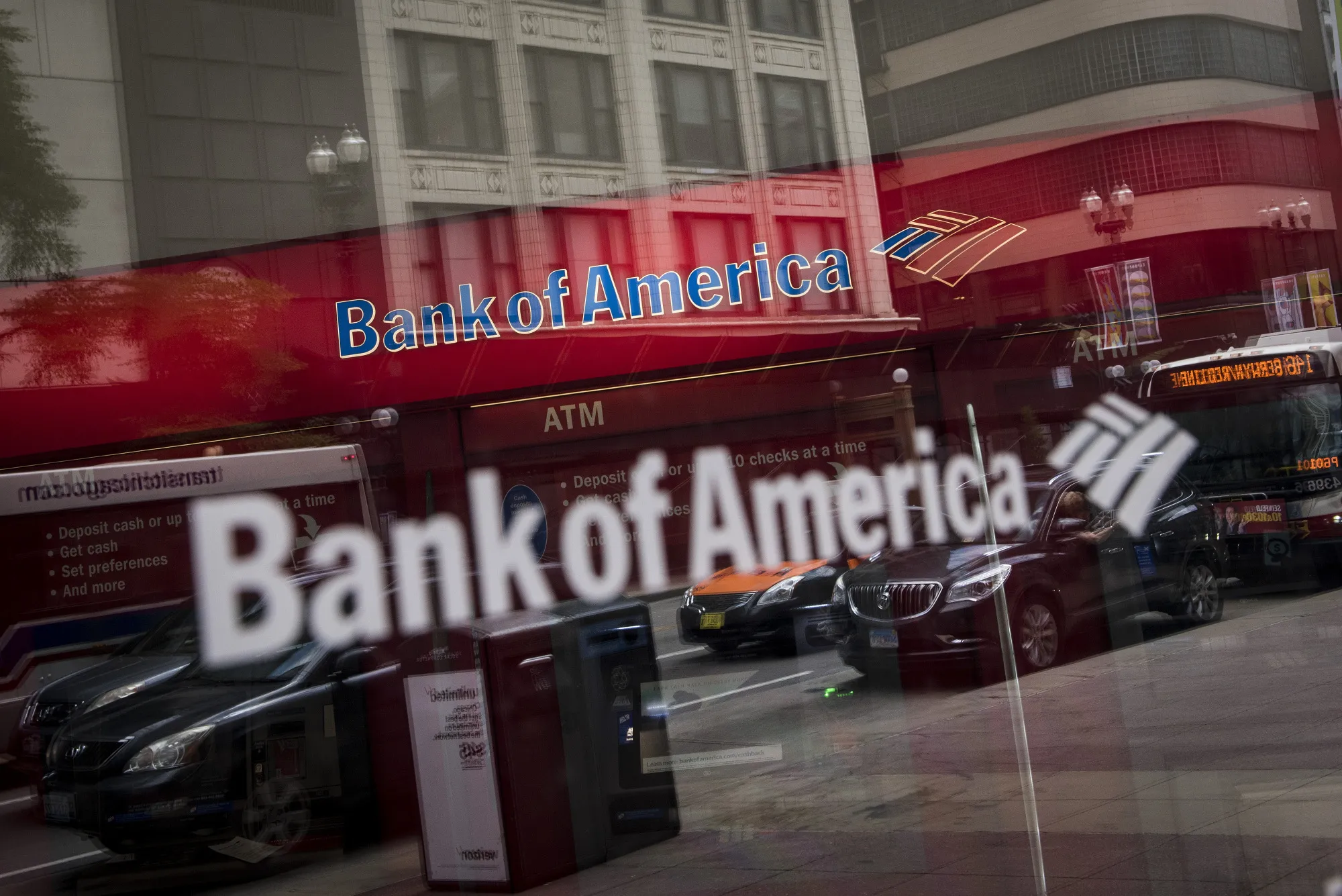 Vehicles are reflected in the window of a Bank of America Corp. branch in Chicago, Illinois, U.S., on Sunday, July 9, 2017.