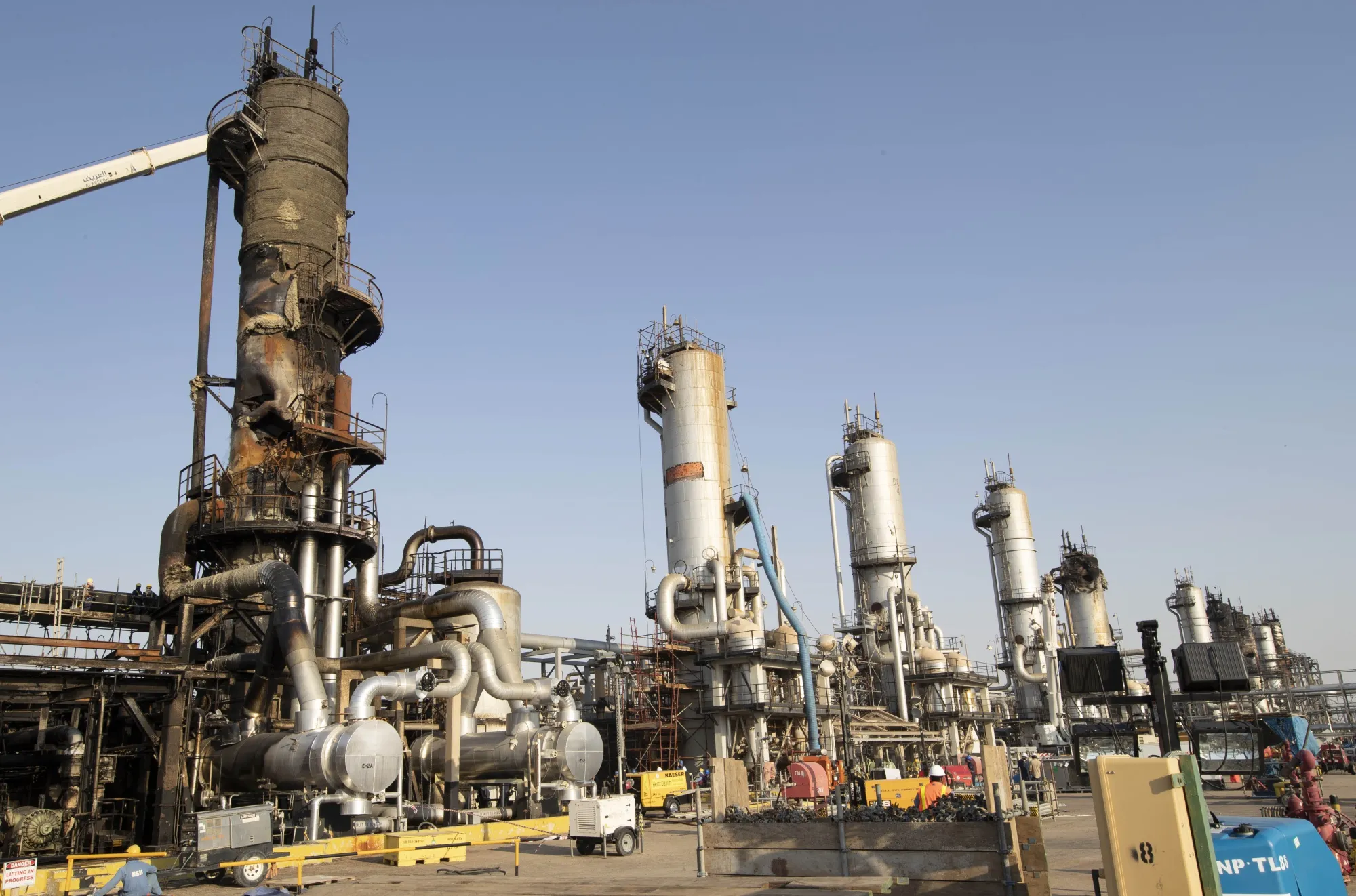 Workers repair a damaged refining tower at Saudi Aramco's Abqaiq crude oil processing plant following a drone attack in Abqaiq, Saudi Arabia on Sept. 20, 2019.
