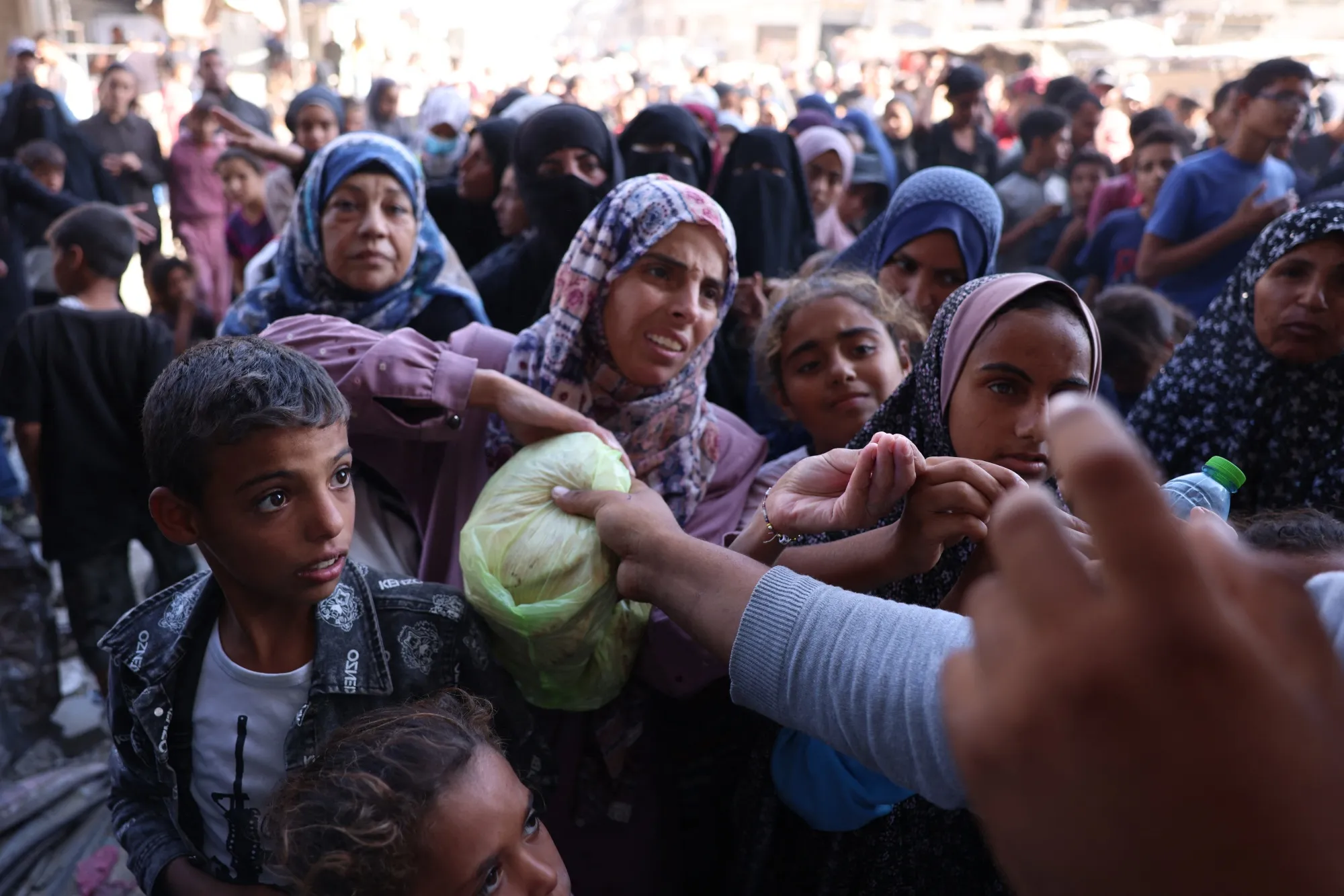 Palestinians queue to receive bread outside a bakery in Khan Yunis on the southern Gaza Strip on Oct. 29.