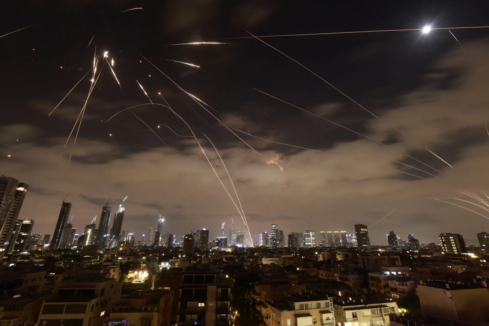 Israeli air defense systems intercept Iranian missiles over Tel Aviv on June 16.