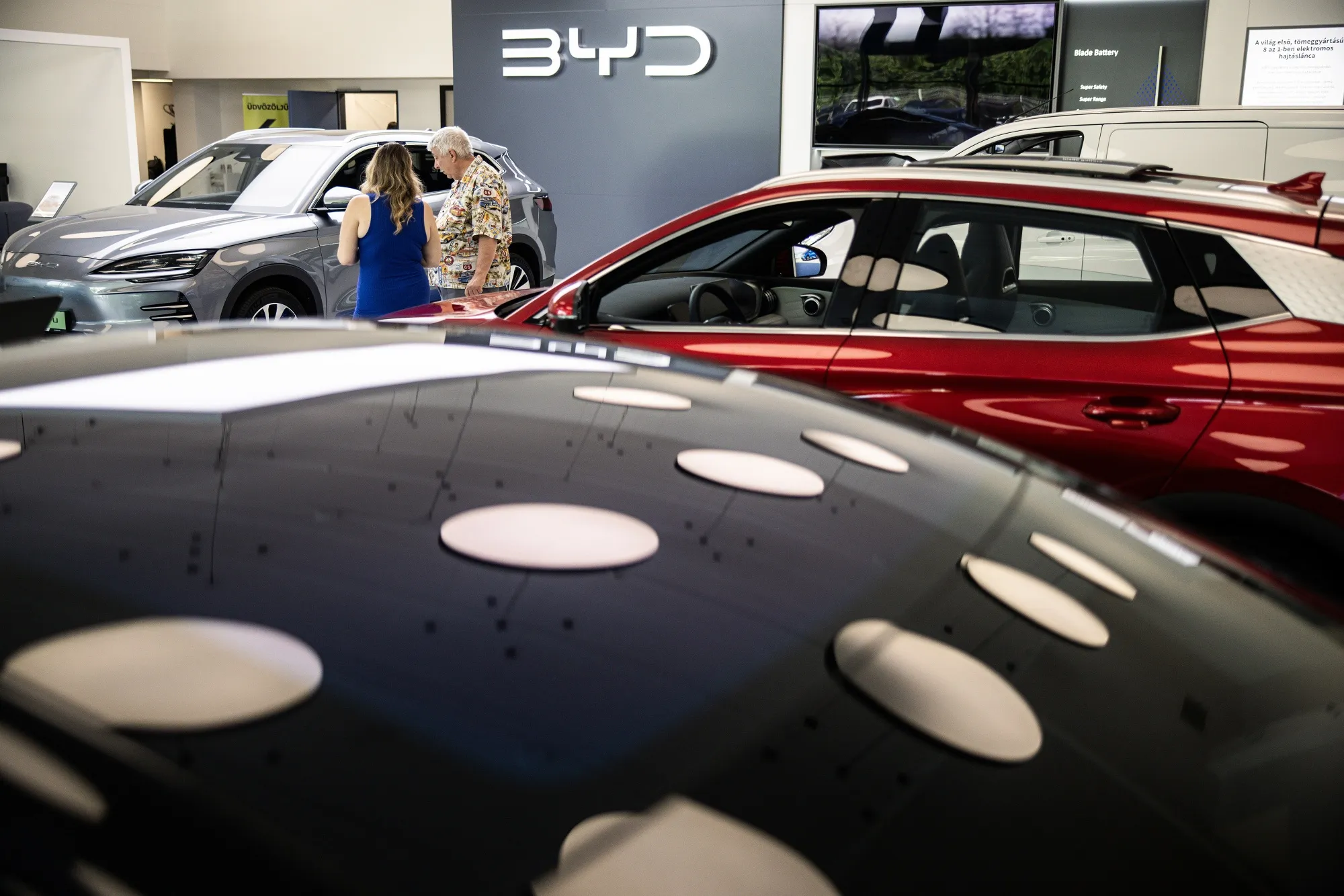 Customers look at electric vehicles at a BYD Co. showroom in Budapest.