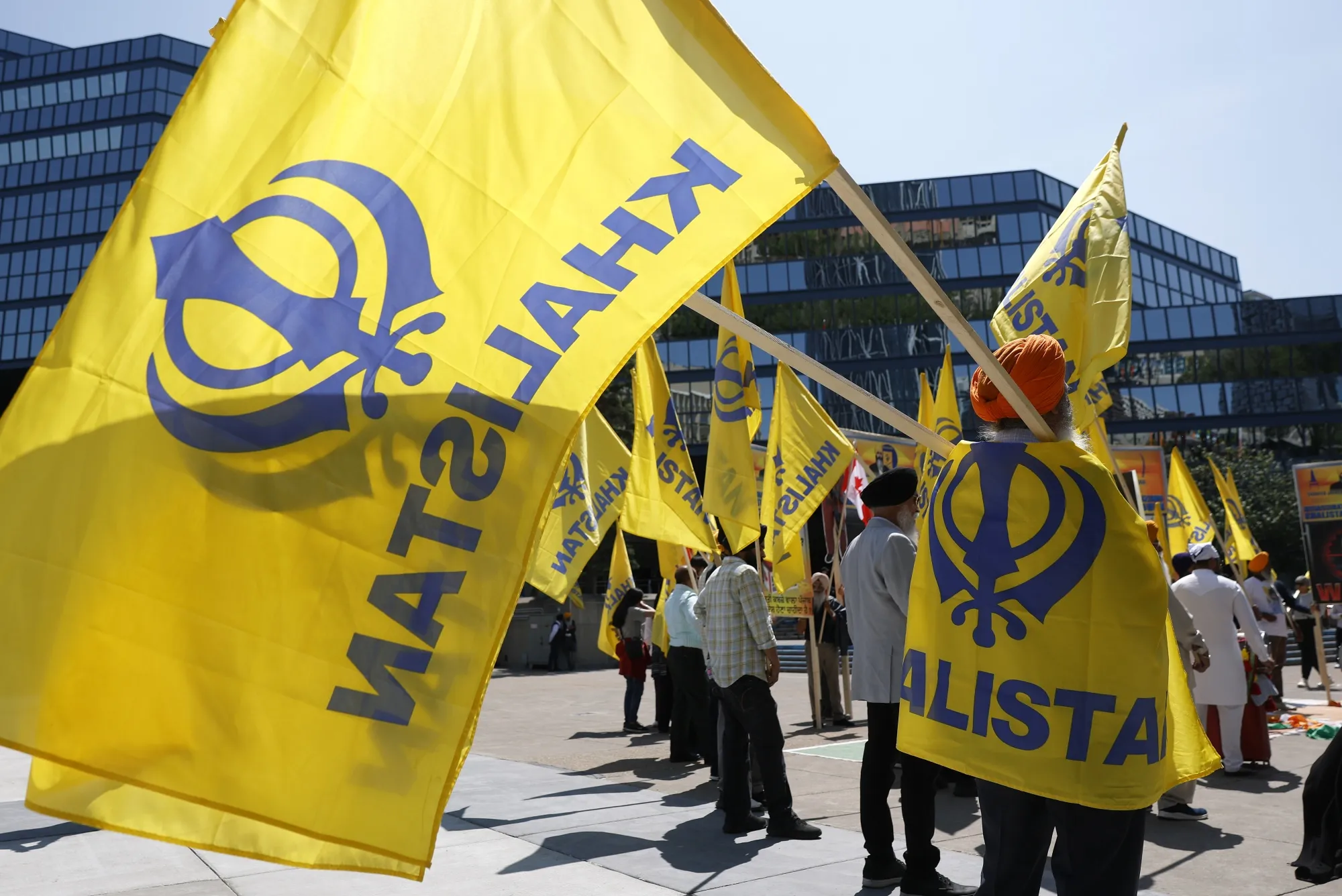 Members of the Sikh community hold flags during a protest&nbsp;in front of Calgary City Hall&nbsp;in Calgary.