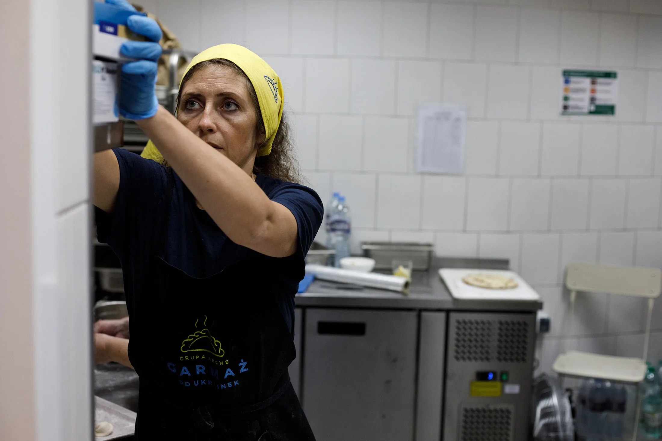 Natalia Hipska, who fled Ukraine with her 12-year-old son, prepares specialties from her home country in a new Warsaw restaurant.